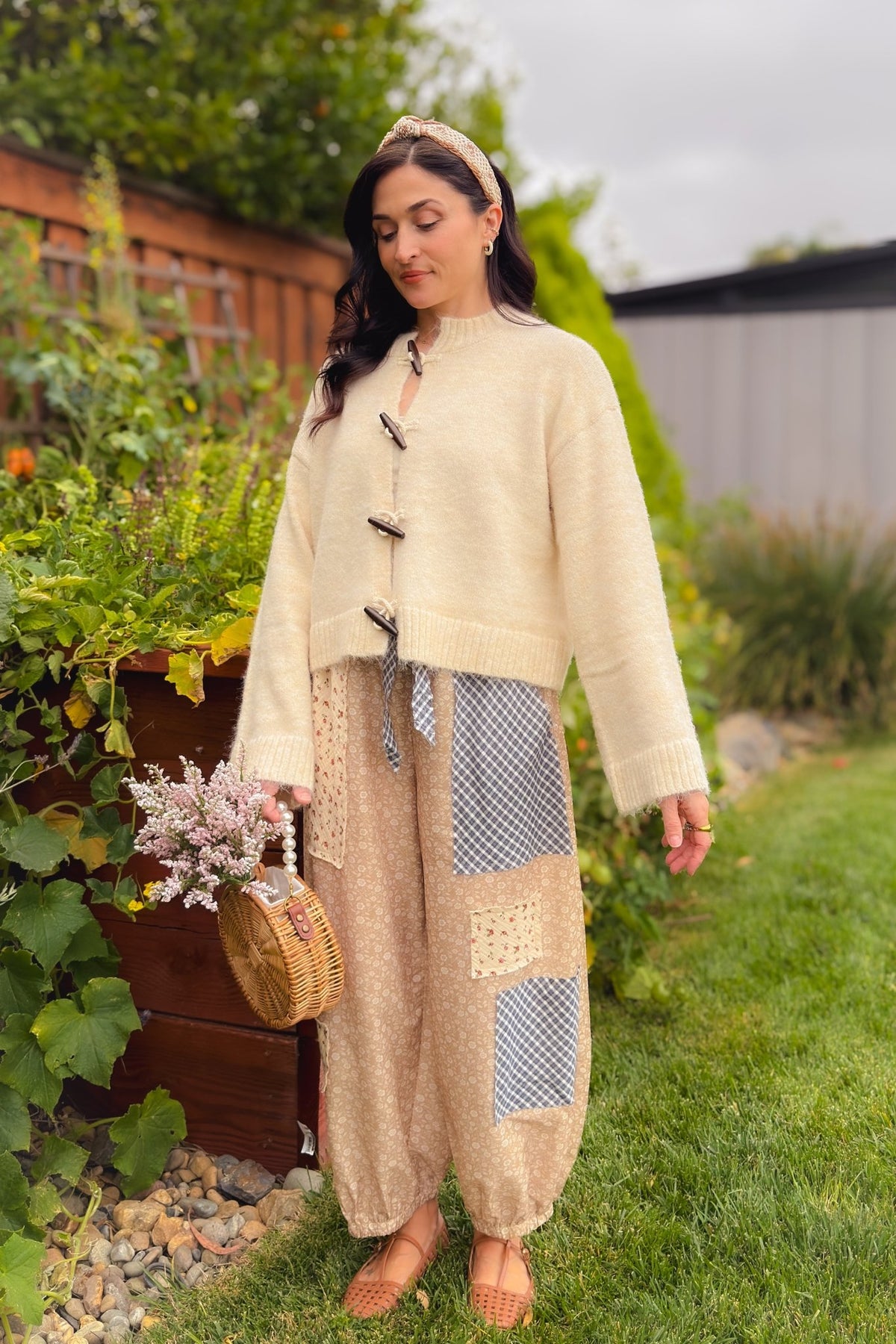 Beige floral patchwork balloon pants styled with a navy button-down shirt and tan woven flats for an easy casual fall outfit.