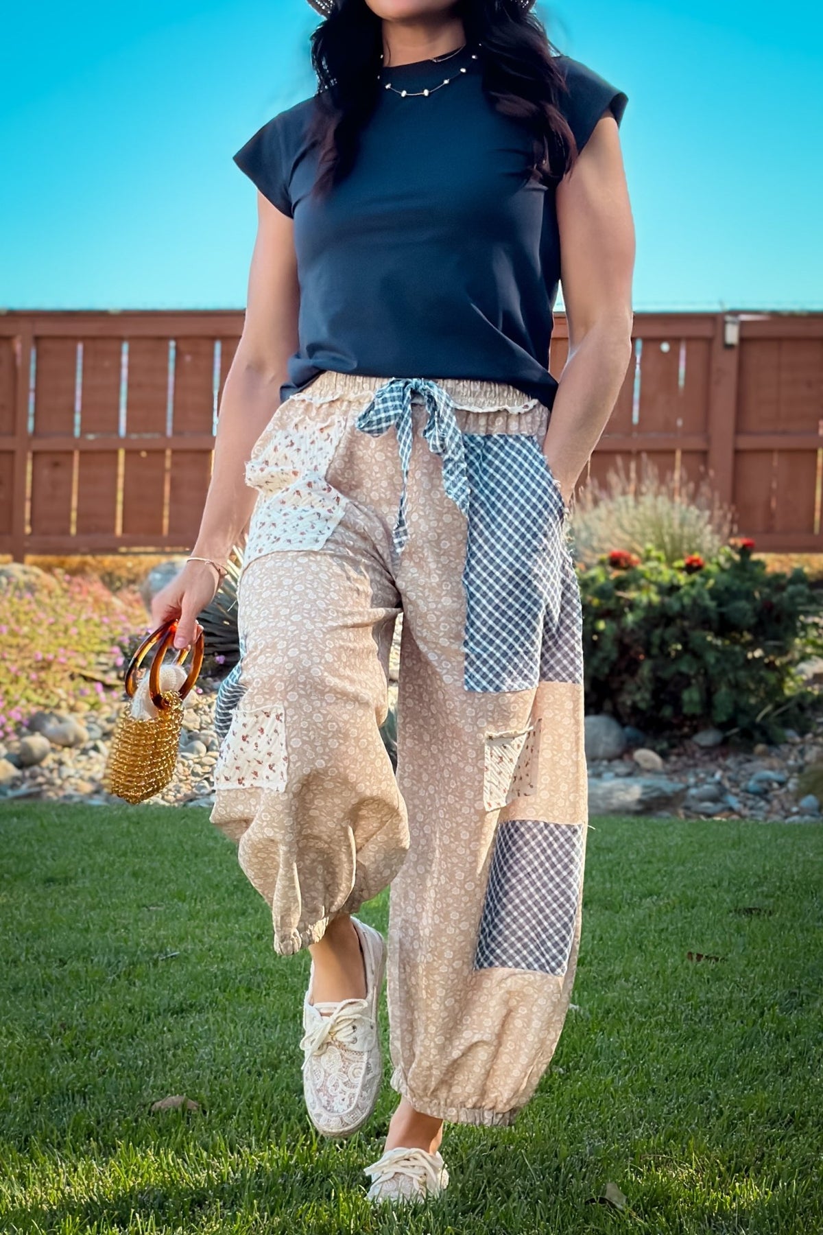 Beige floral patchwork balloon pants featuring mixed prints, oversized patch pockets, relaxed balloon legs and gathered elastic hems.