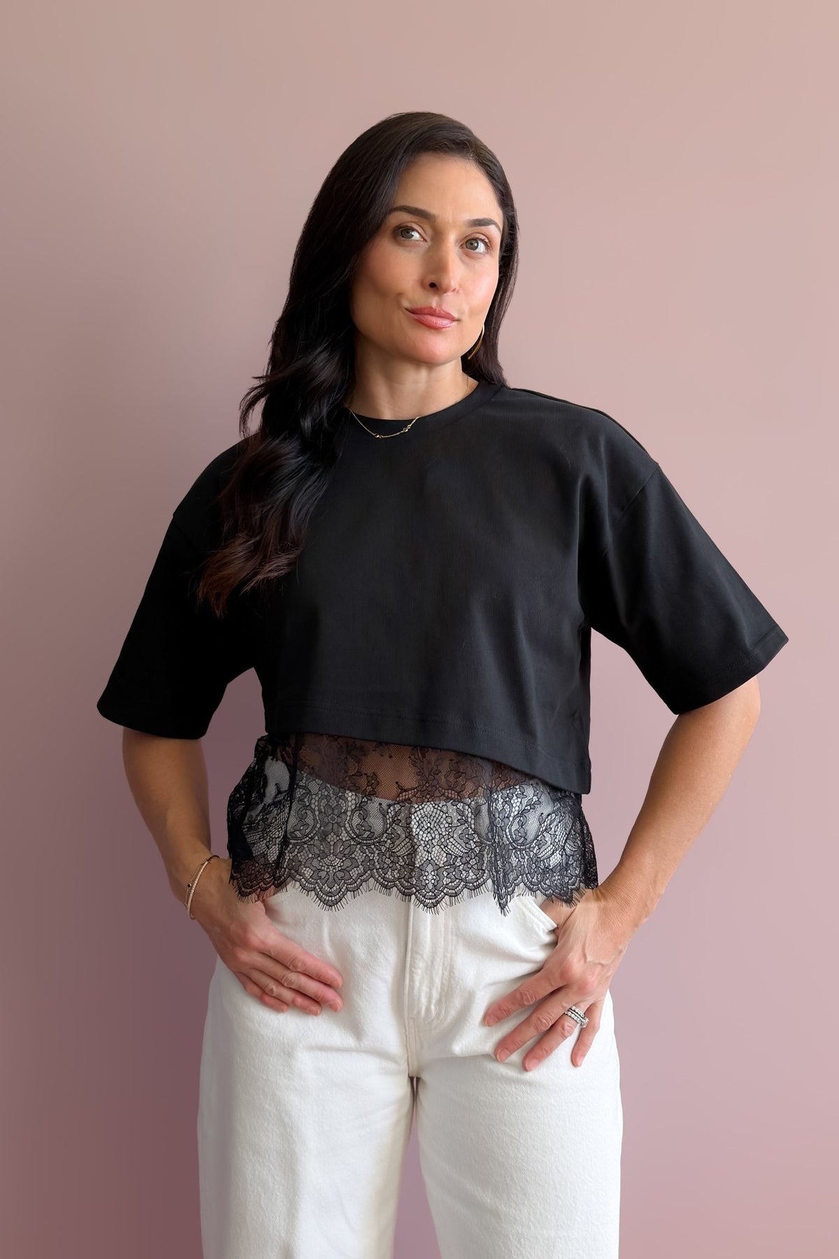 Black 100% cotton asymmetrical lace hem tee with structured fit and sheer floral lace trim
