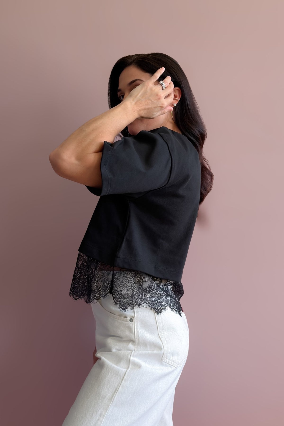 Structured black cotton tee with asymmetrical floral lace hem and crew neckline