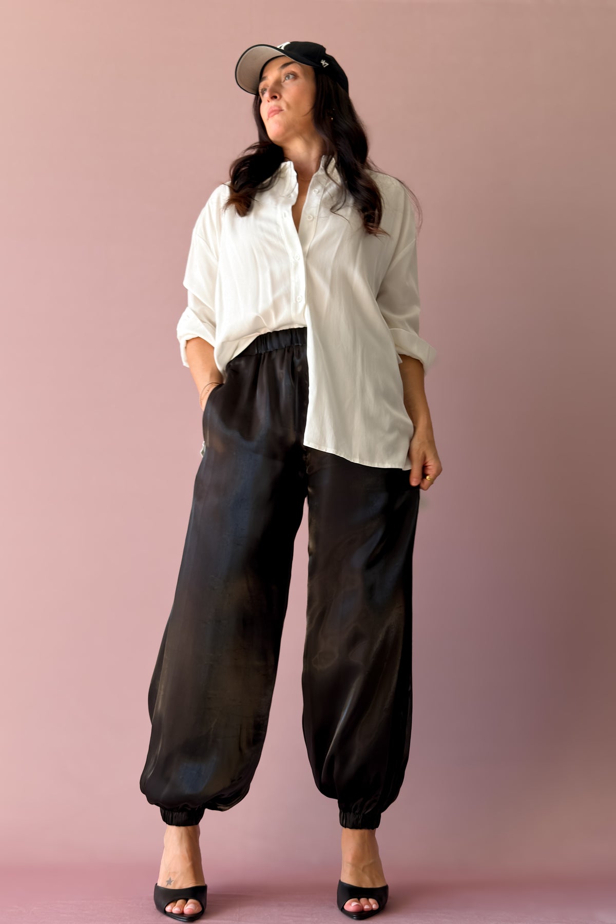 Women’s black dressy jogger pants with luminous sheen and gathered ankles