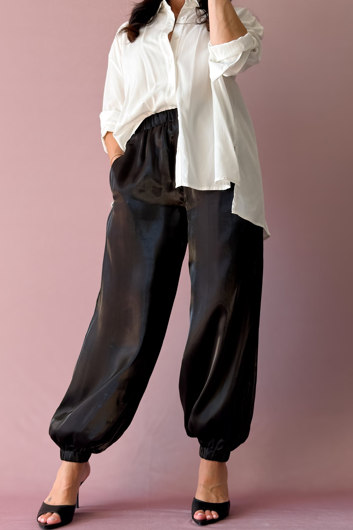 Black organza jogger pants with elastic waist and tailored balloon-leg silhouette