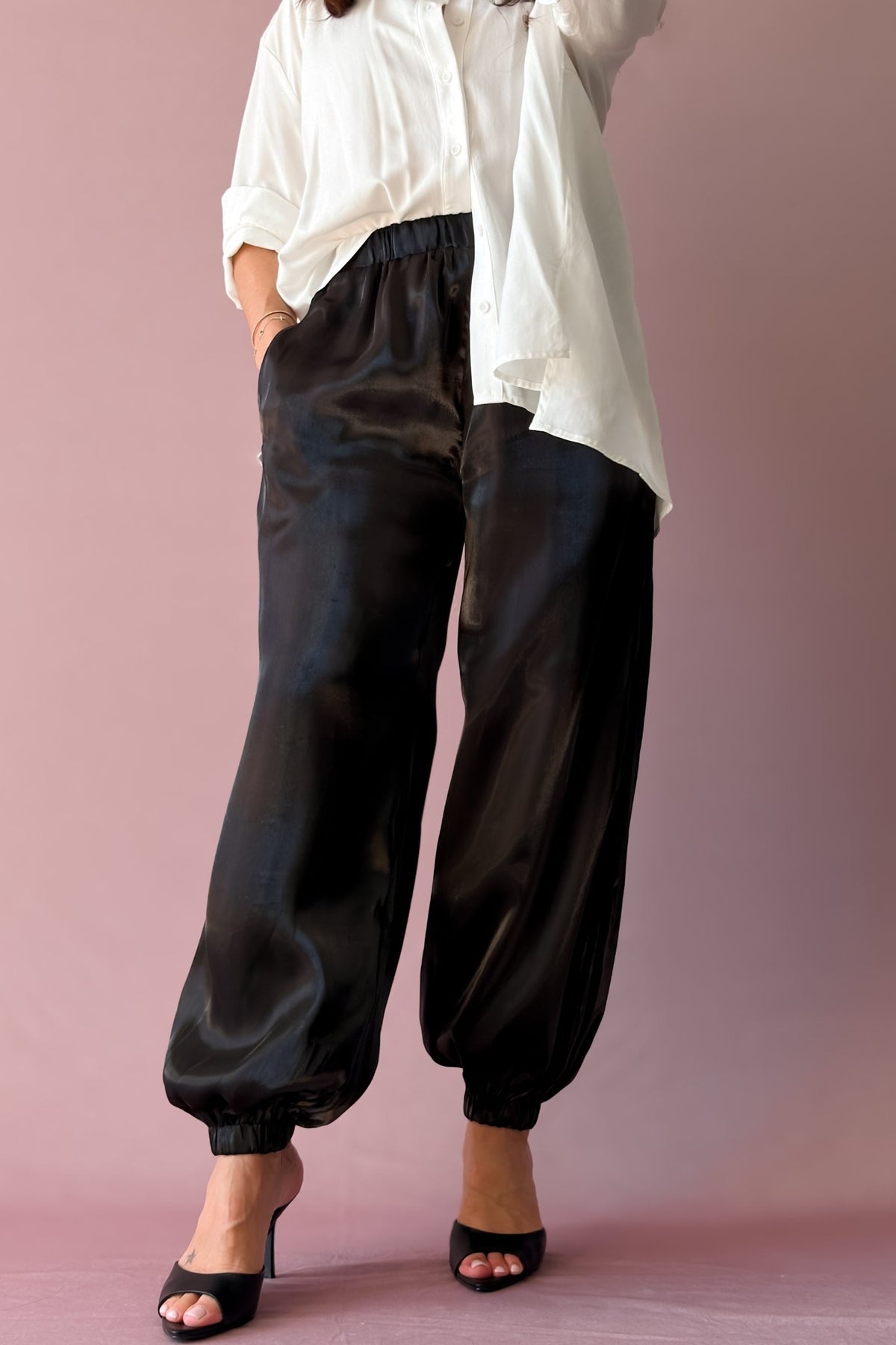 1. Opaque black organza pants with elastic waistband and tailored balloon silhouette