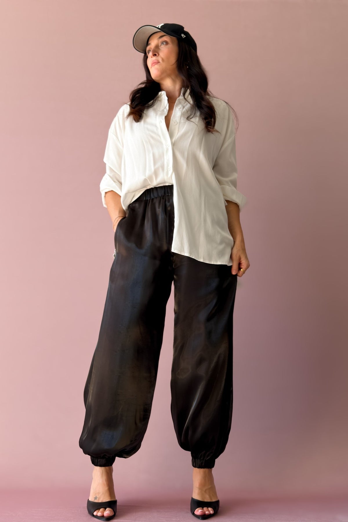 Women’s black dressy jogger pants with luminous sheen and gathered ankles