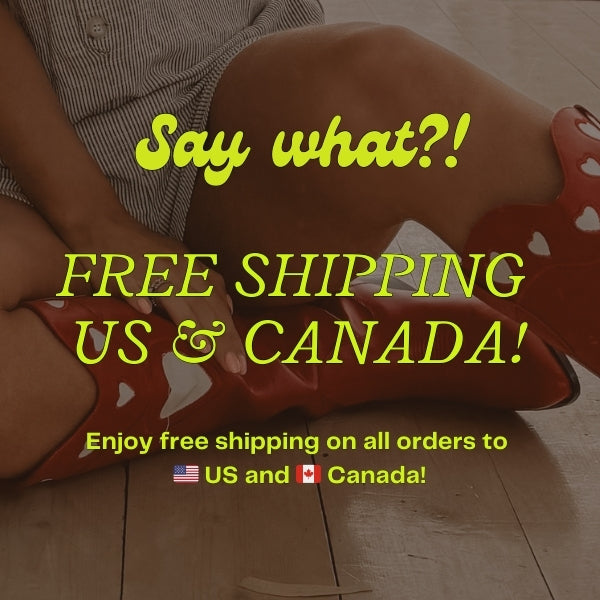 Close-up of a woman sitting on the floor wearing a striped outfit and red heart-printed boots. The text overlay reads "Say what?! Free Shipping US & Canada! Enjoy free shipping on all orders to the US and Canada!" The image promotes free shipping for orders to the United States and Canada.