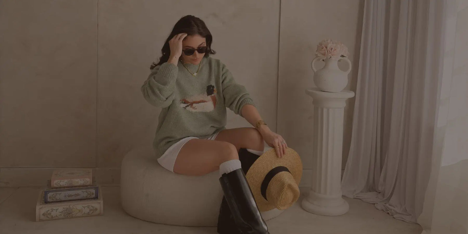 Blooming Daily women’s boutique outfit featuring sage green duck sweater styled with boots and straw hat for elevated everyday fashion