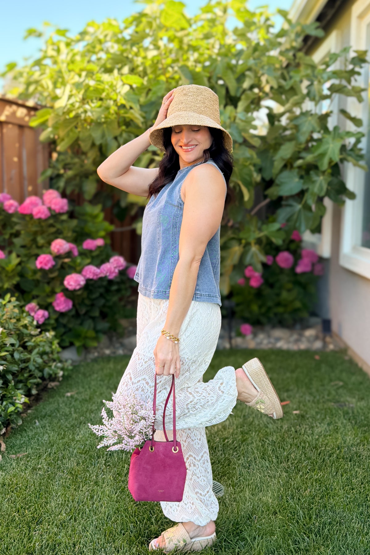 Casual summer outfit featuring a lightweight blue denim sleeveless top, lace pants, and neutral platform sandals.
