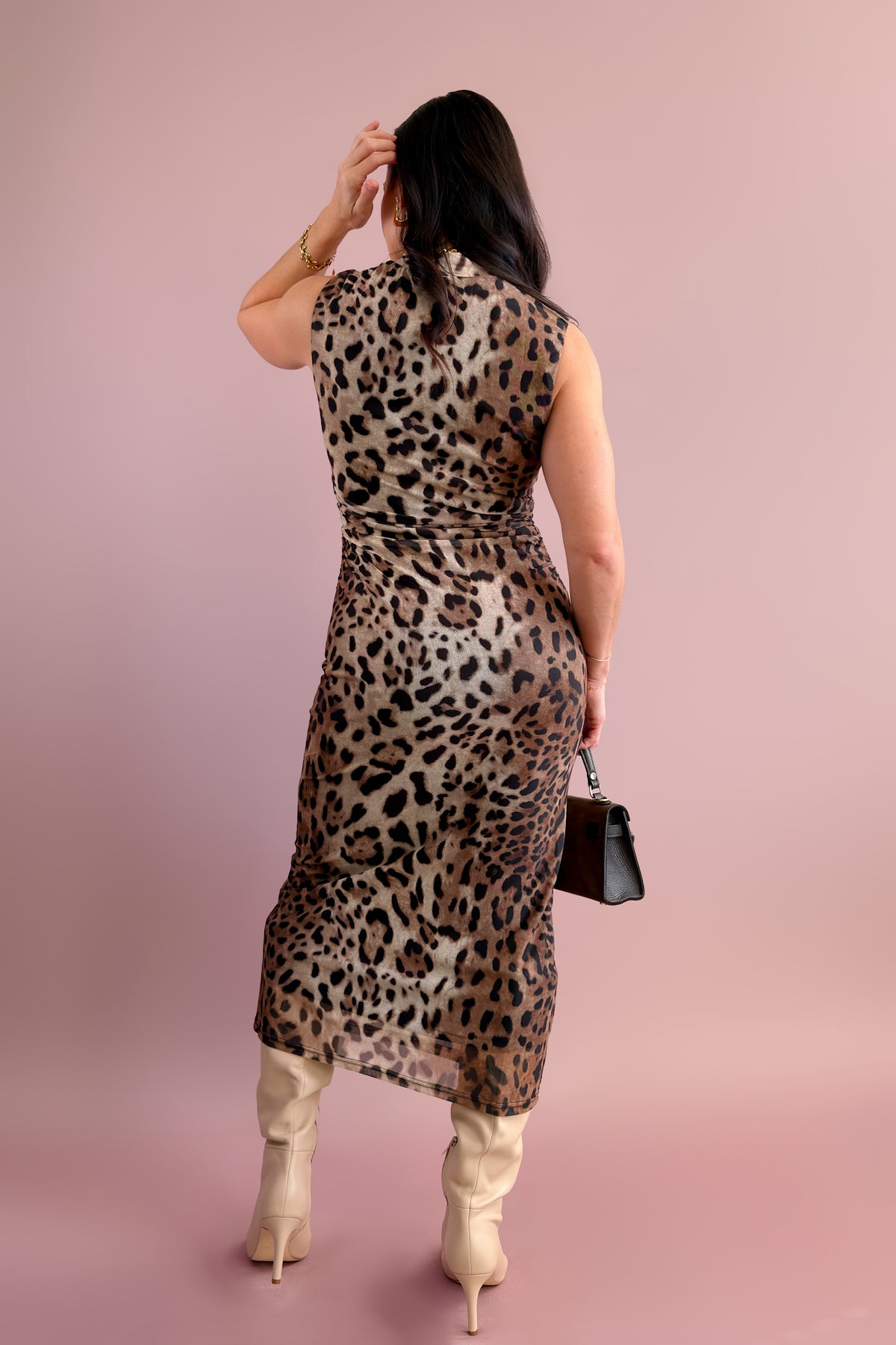 Women's fitted leopard print midi dress featuring flattering midsection ruching.