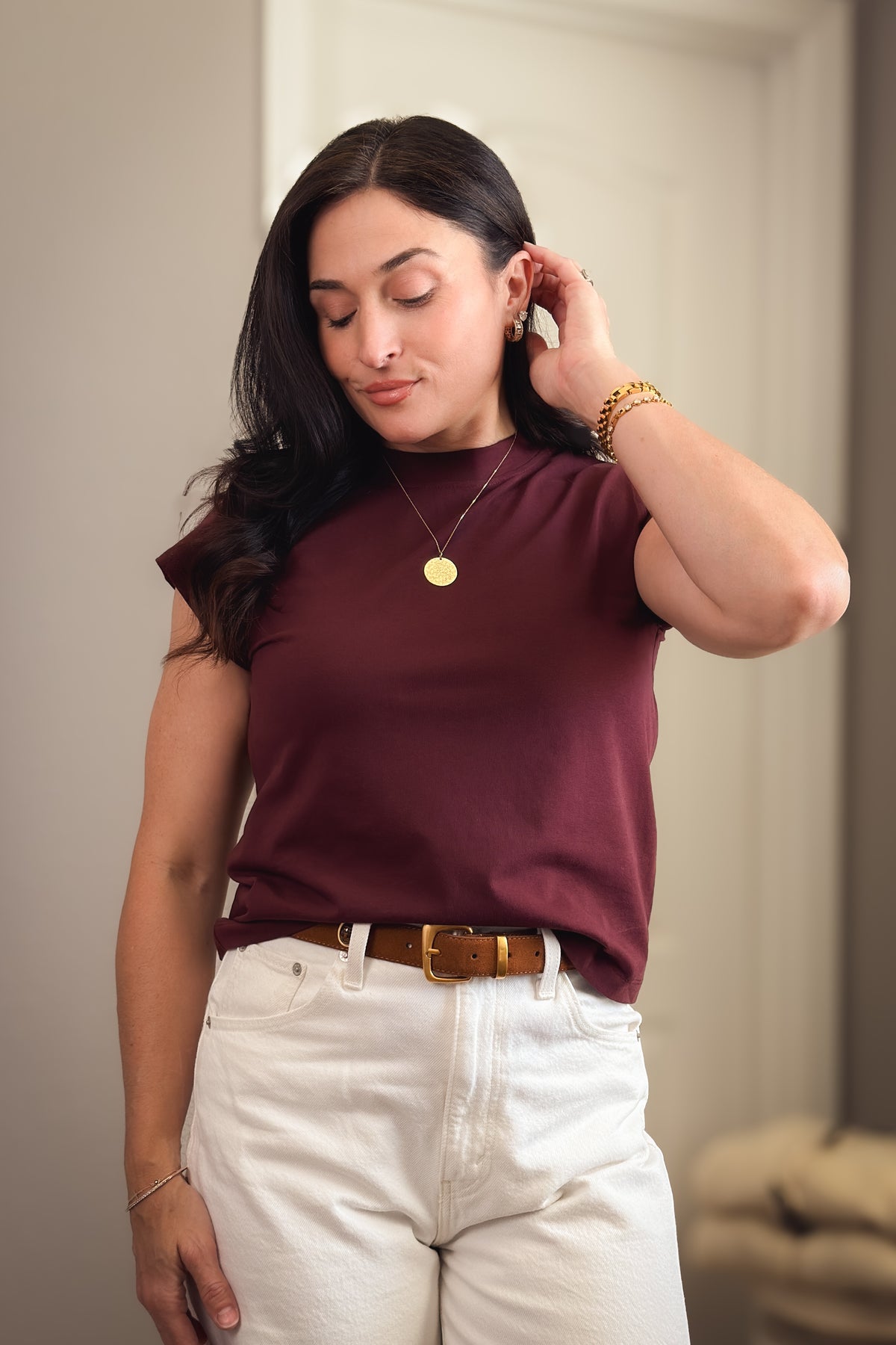 Burgundy short sleeve cotton-blend top with a classic crew neckline styled with white denim for fall.