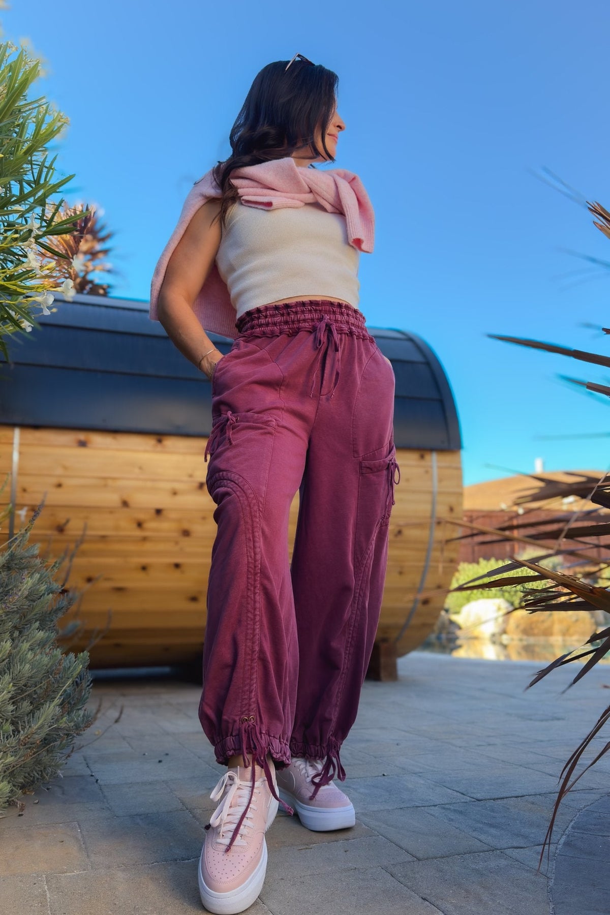 Burgundy balloon-style cargo pants for women with oversized pockets and adjustable ankle drawstrings
