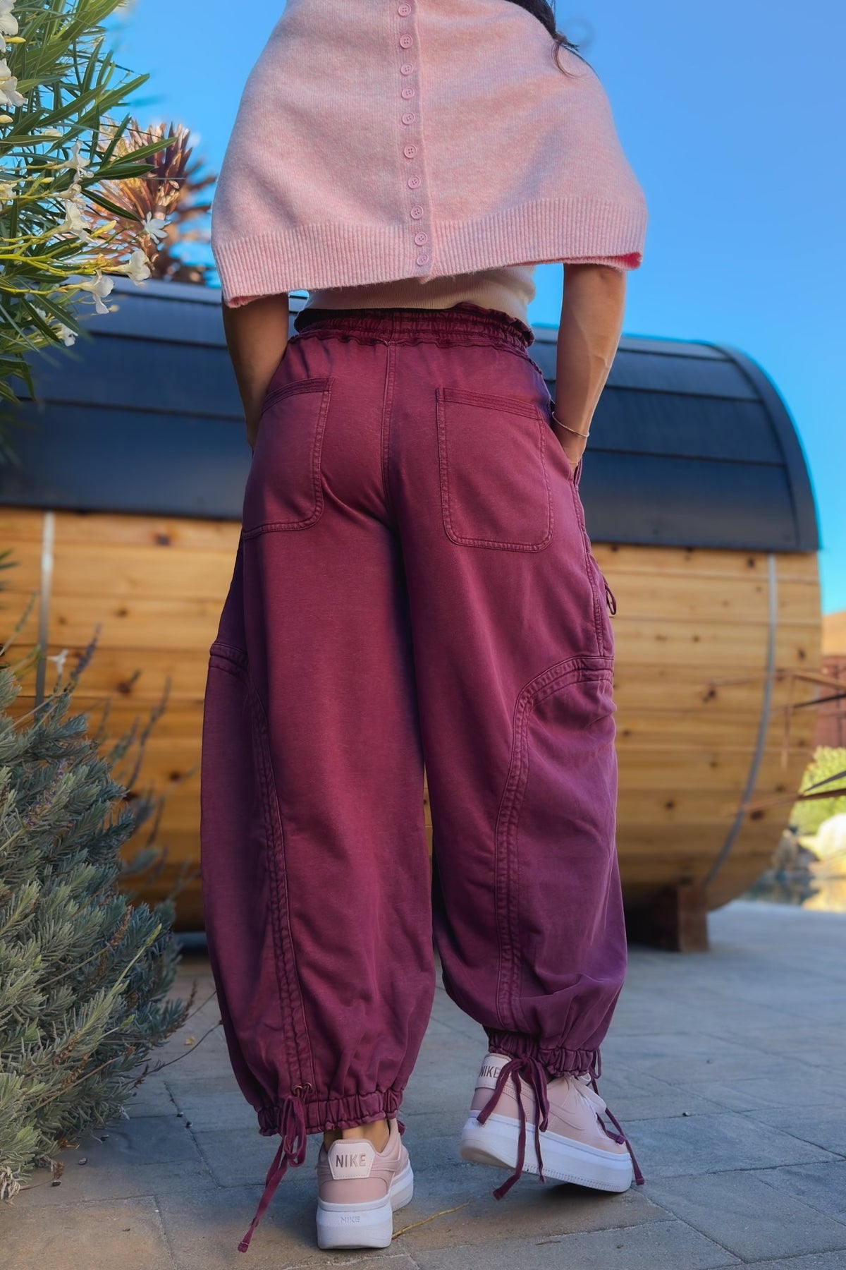 Back view of burgundy mineral wash cargo pants with functional patch pockets and relaxed fit