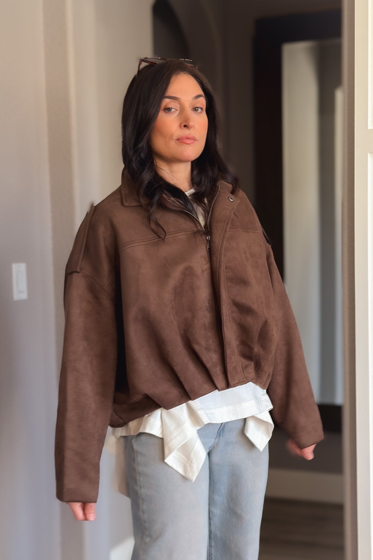 Women’s brown microsuede bomber jacket with a zip front, soft structured collar and boxy silhouette.