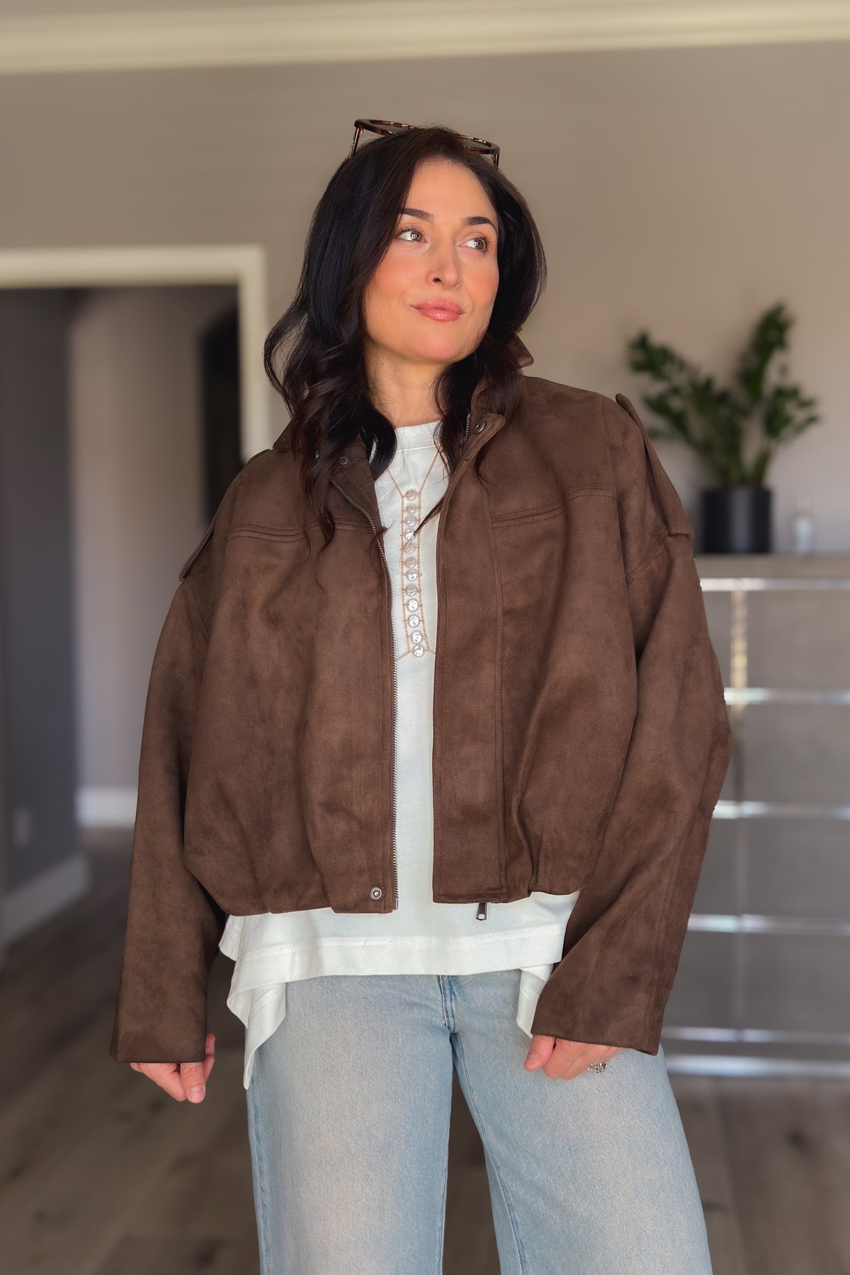 Chocolate brown faux suede outerwear styled with light denim for a casual polished fall look.