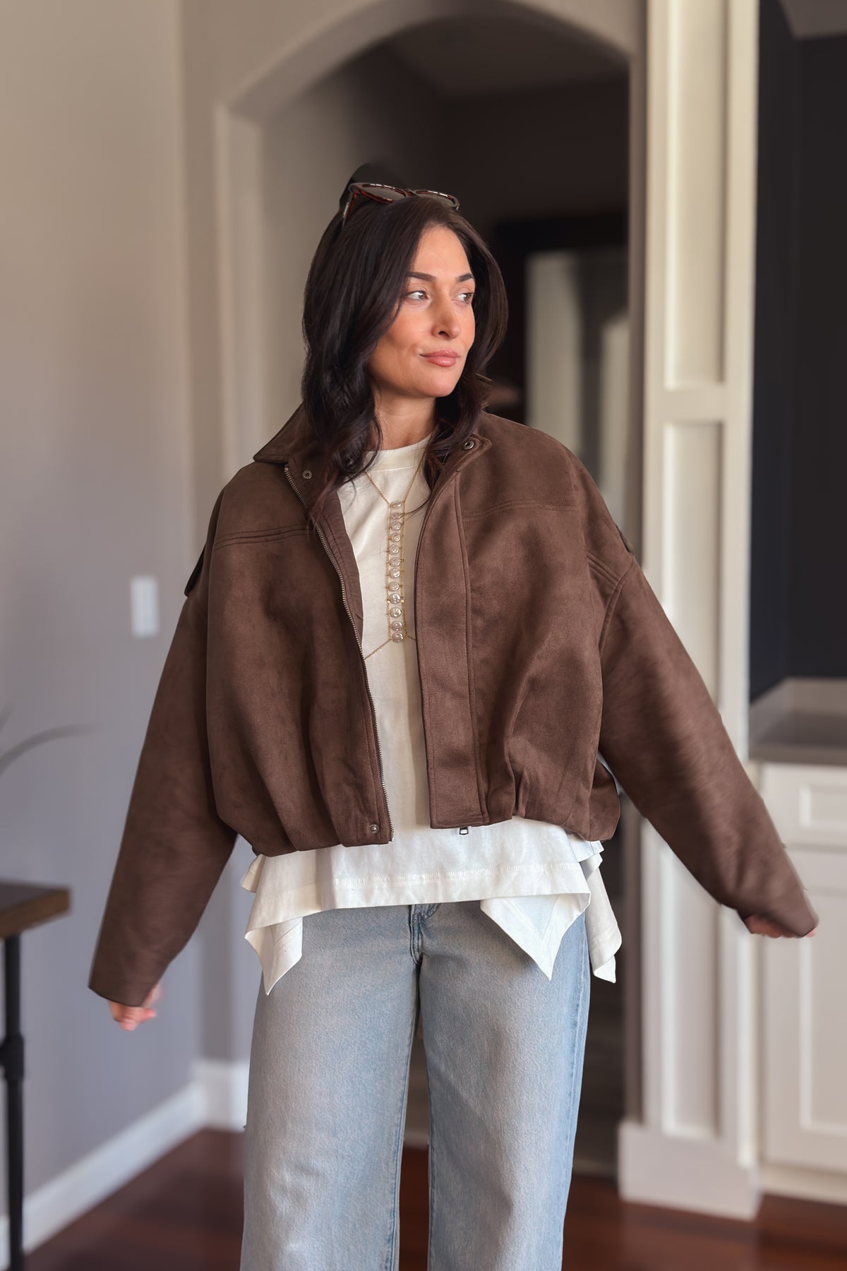 Women’s brown faux suede bomber jacket with roomy sleeves and a flattering boxy silhouette.