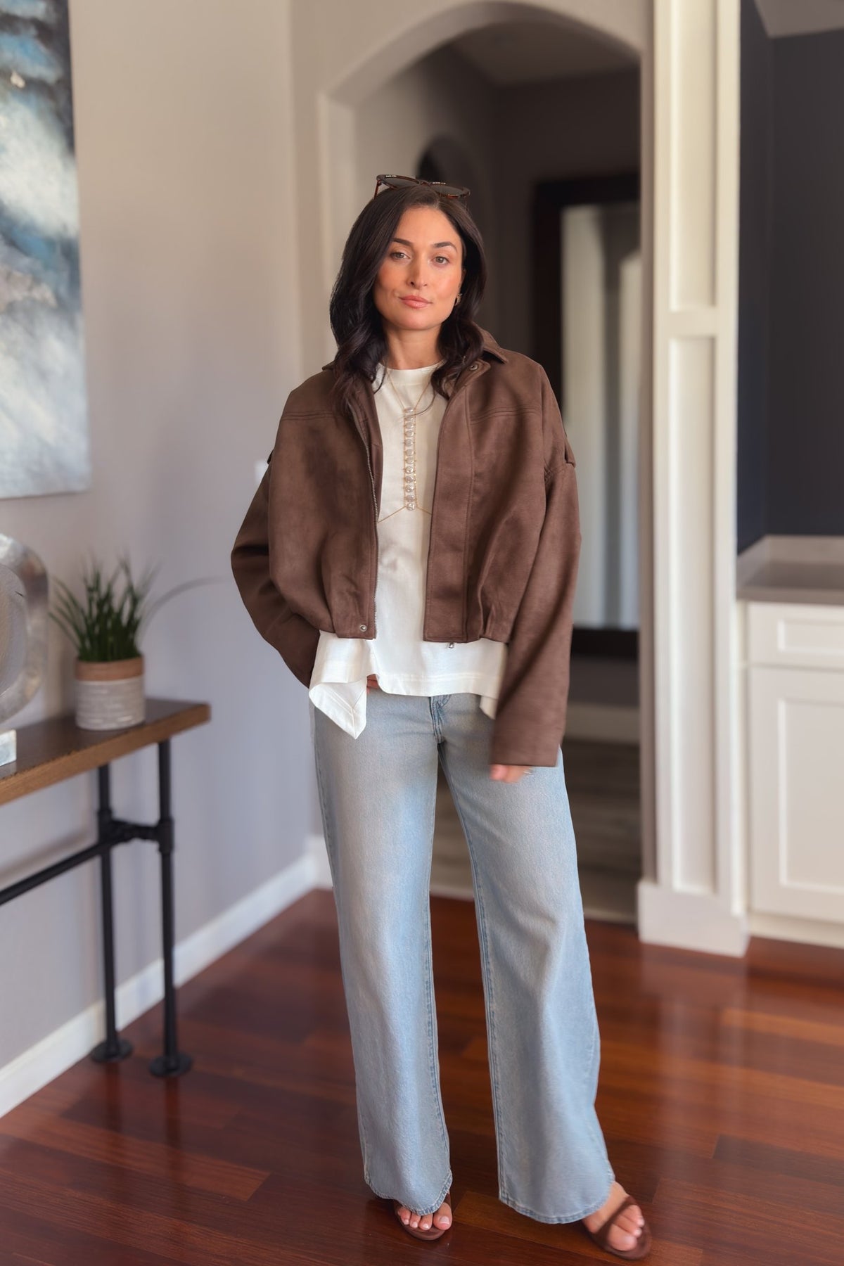 Chocolate brown bomber jacket in soft faux suede with a relaxed drape and easy layering fit.