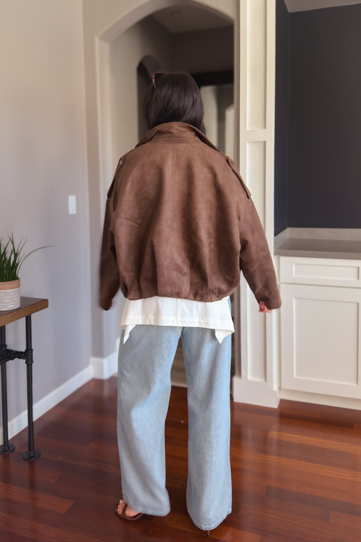 Brown faux suede bomber jacket styled with wide-leg denim for an easy elevated fall outfit.