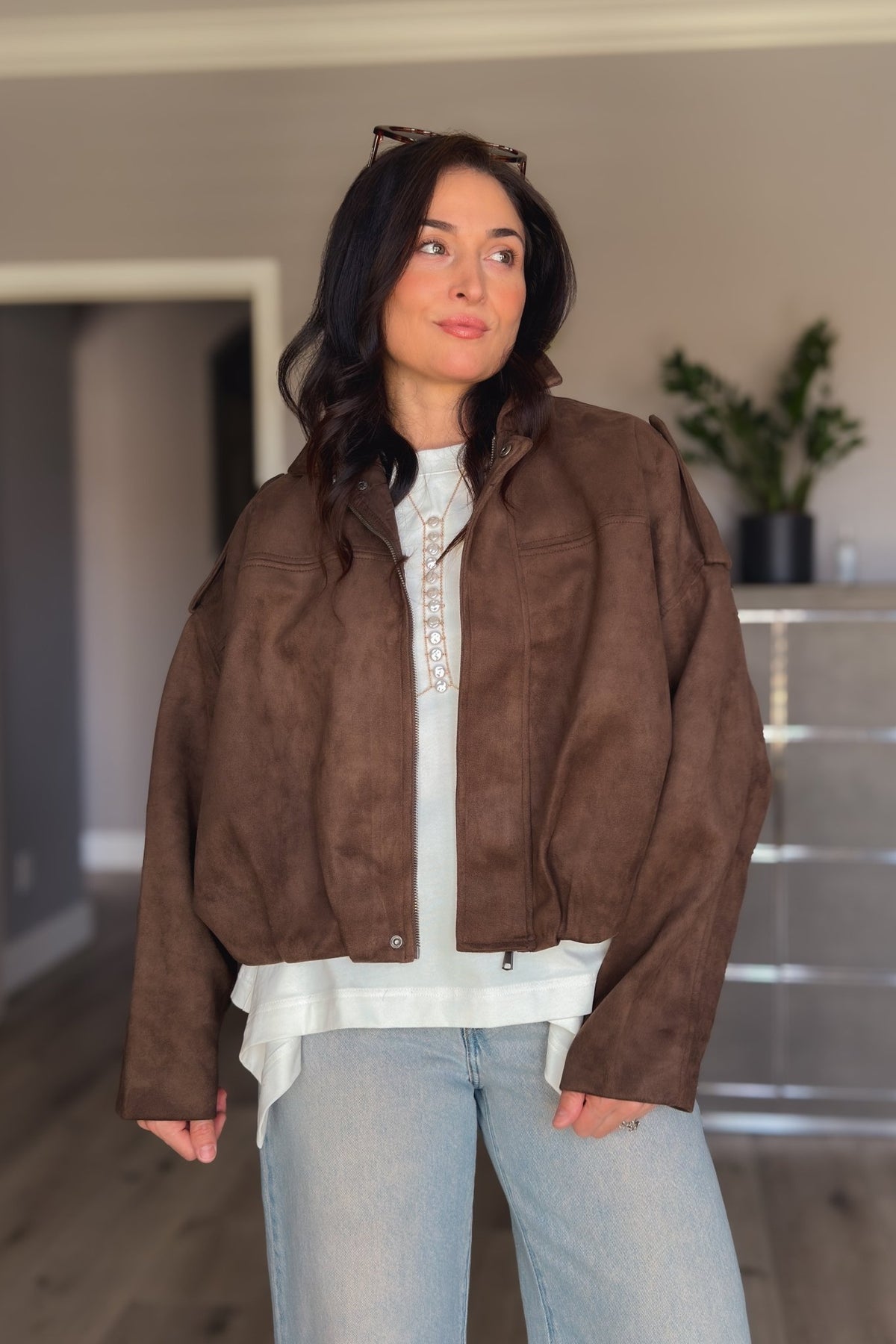 Chocolate brown faux suede outerwear styled with light denim for a casual polished fall look.
