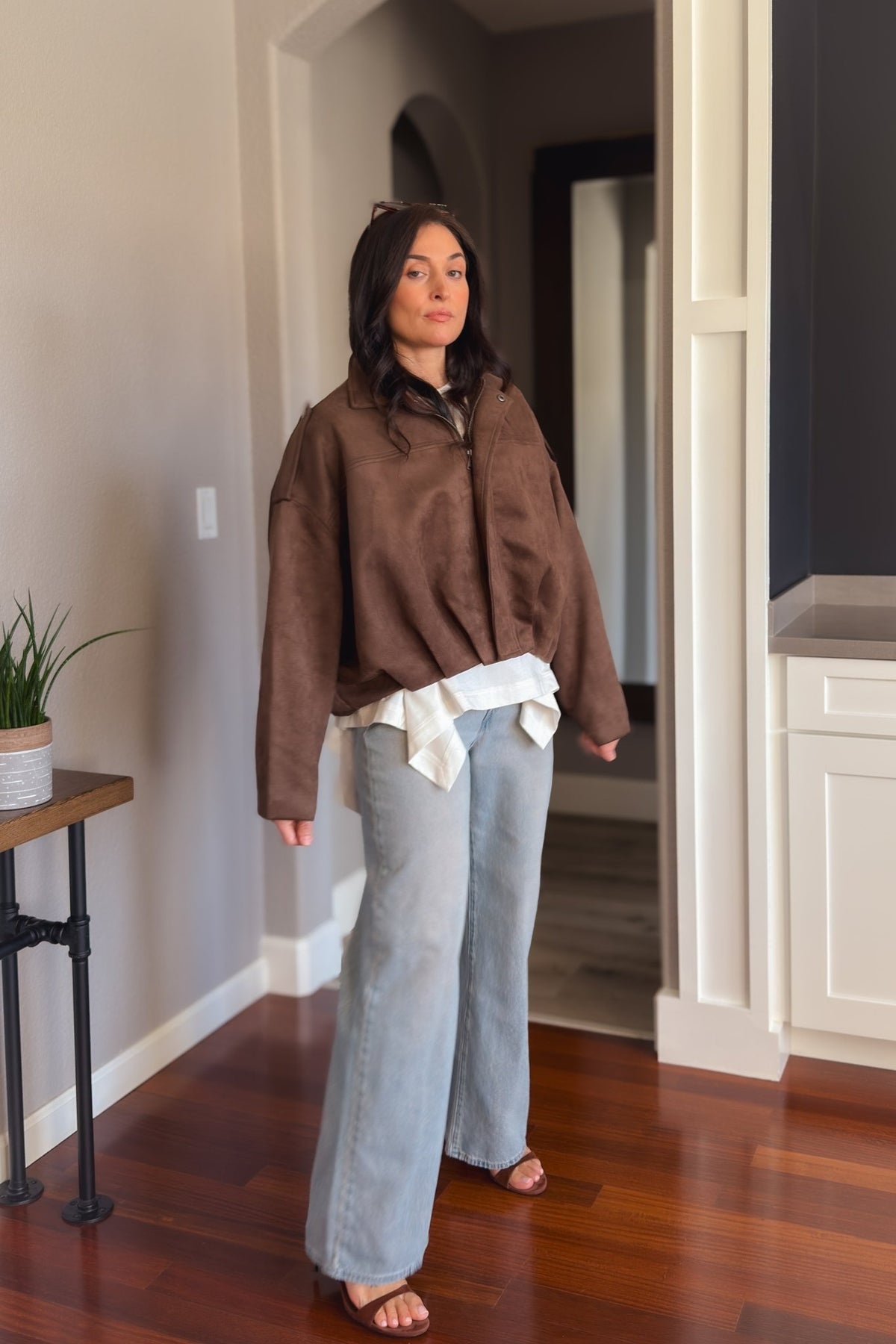 Brown lightweight faux suede jacket with a clean hem designed without a tight elastic waistband.