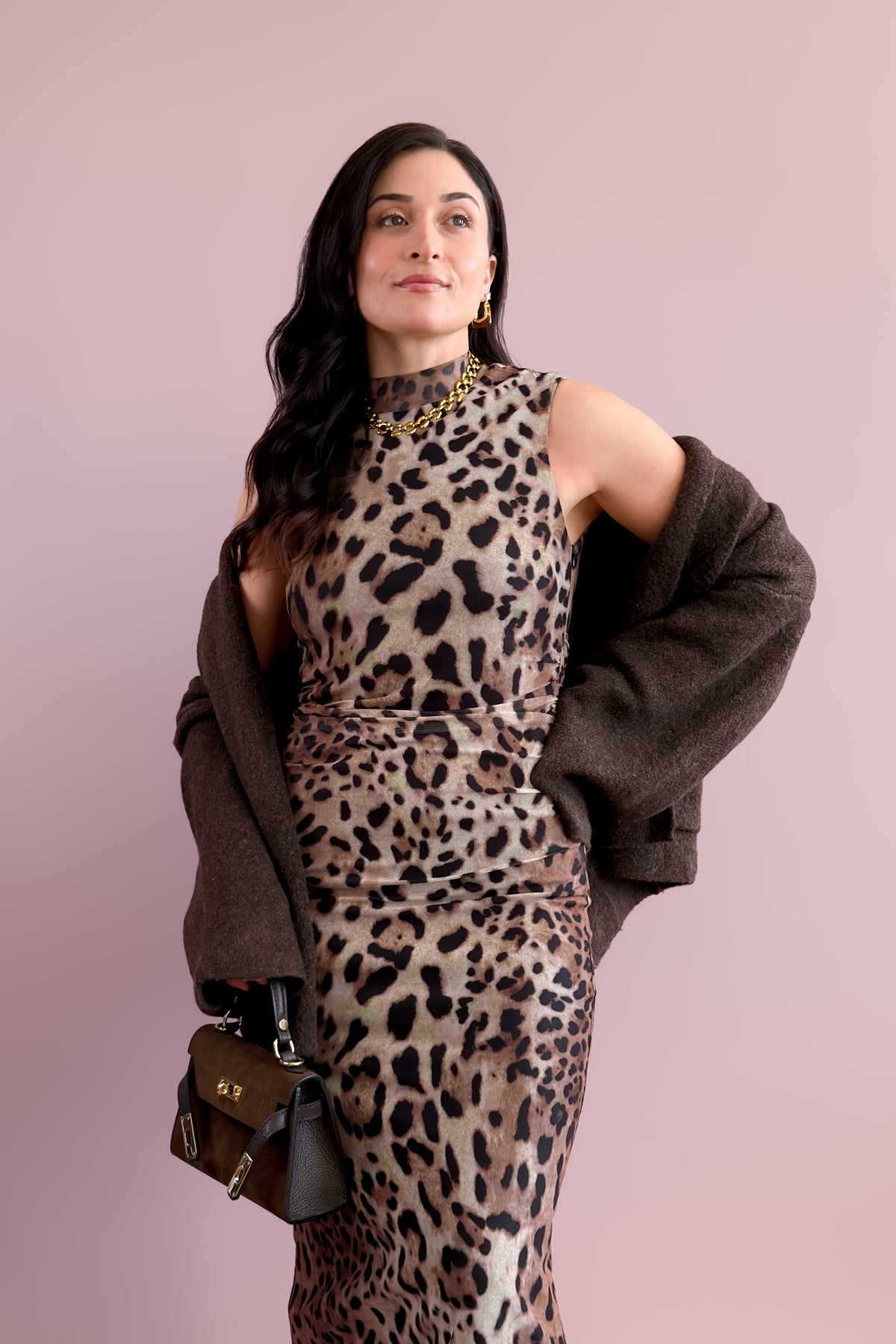 Oversized brown cardigan with patch pockets and a relaxed, hip-length silhouette.
