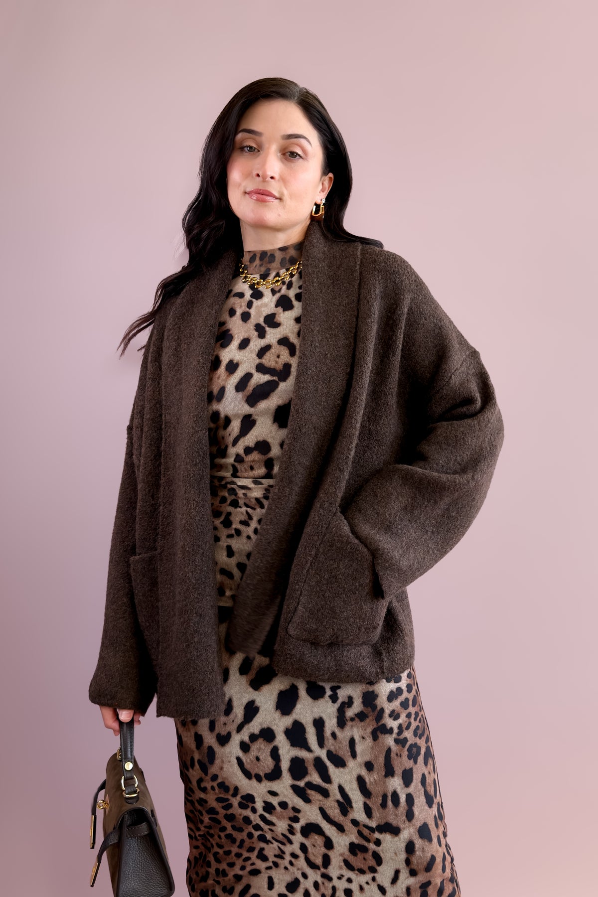 Chocolate brown oversized open front cardigan sweater styled over a leopard print midi dress.