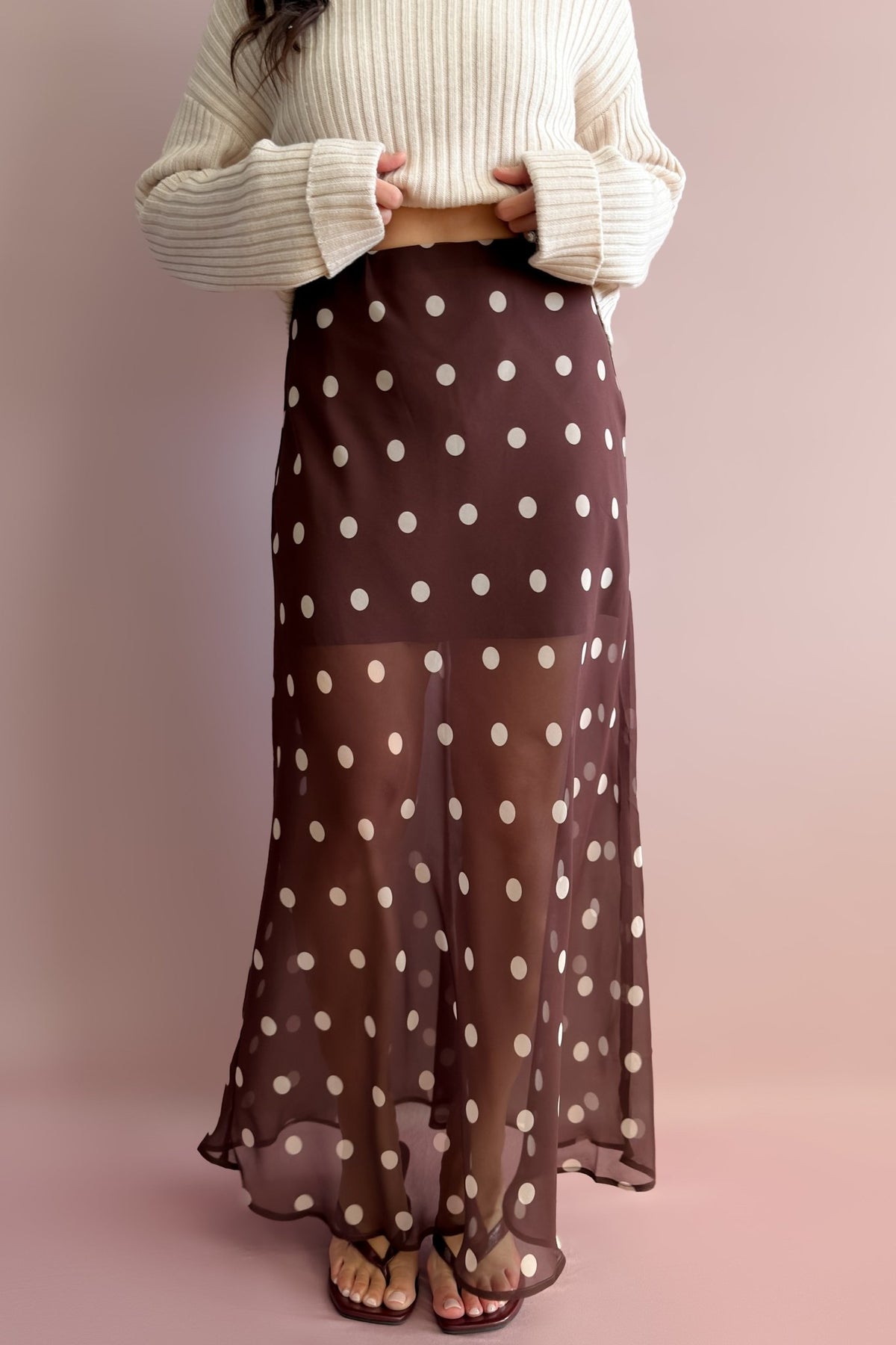 Chocolate brown polka dot sheer maxi skirt with cream spots, partial lining, and flowing floor-length silhouette