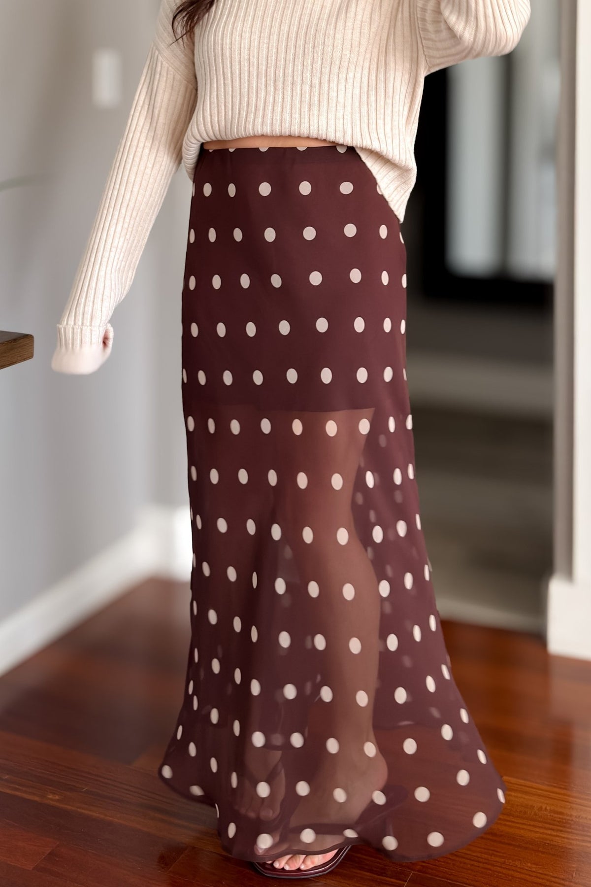 Elegant brown polka dot skirt with partial lining, sheer hem, and long fluid silhouette