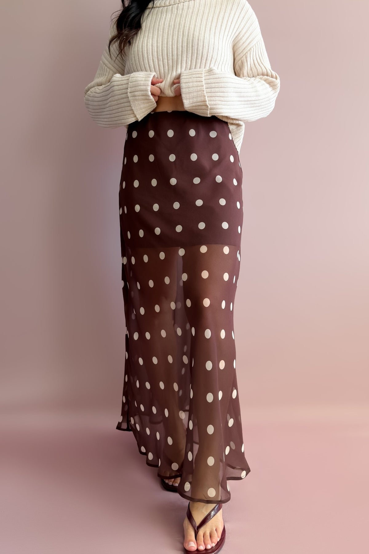 Chocolate brown maxi skirt with cream polka dots, fitted through the hips with a soft sheer drape below the lining