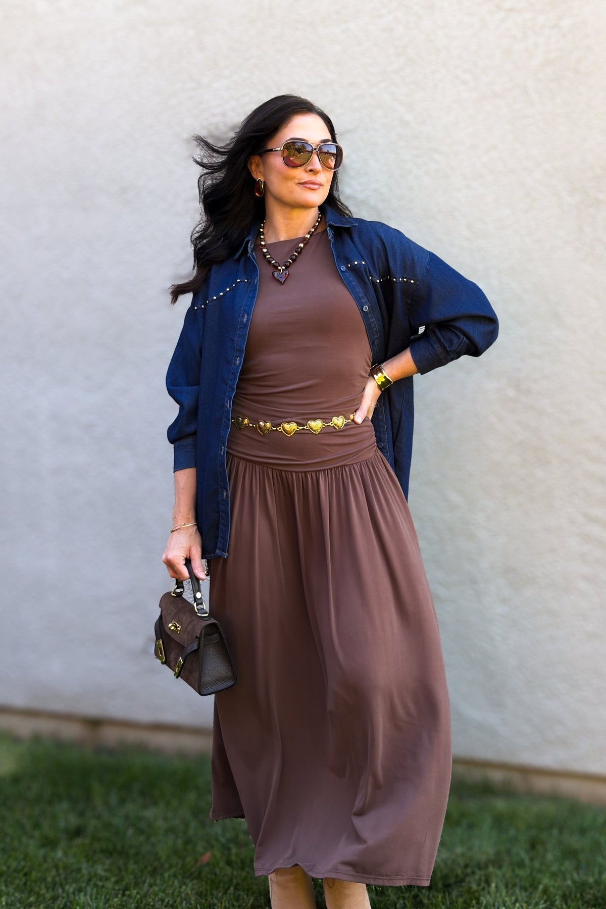 Chocolate brown casual maxi dress with a fitted sleeveless bodice and full flowing skirt, styled as an easy everyday wardrobe staple.
