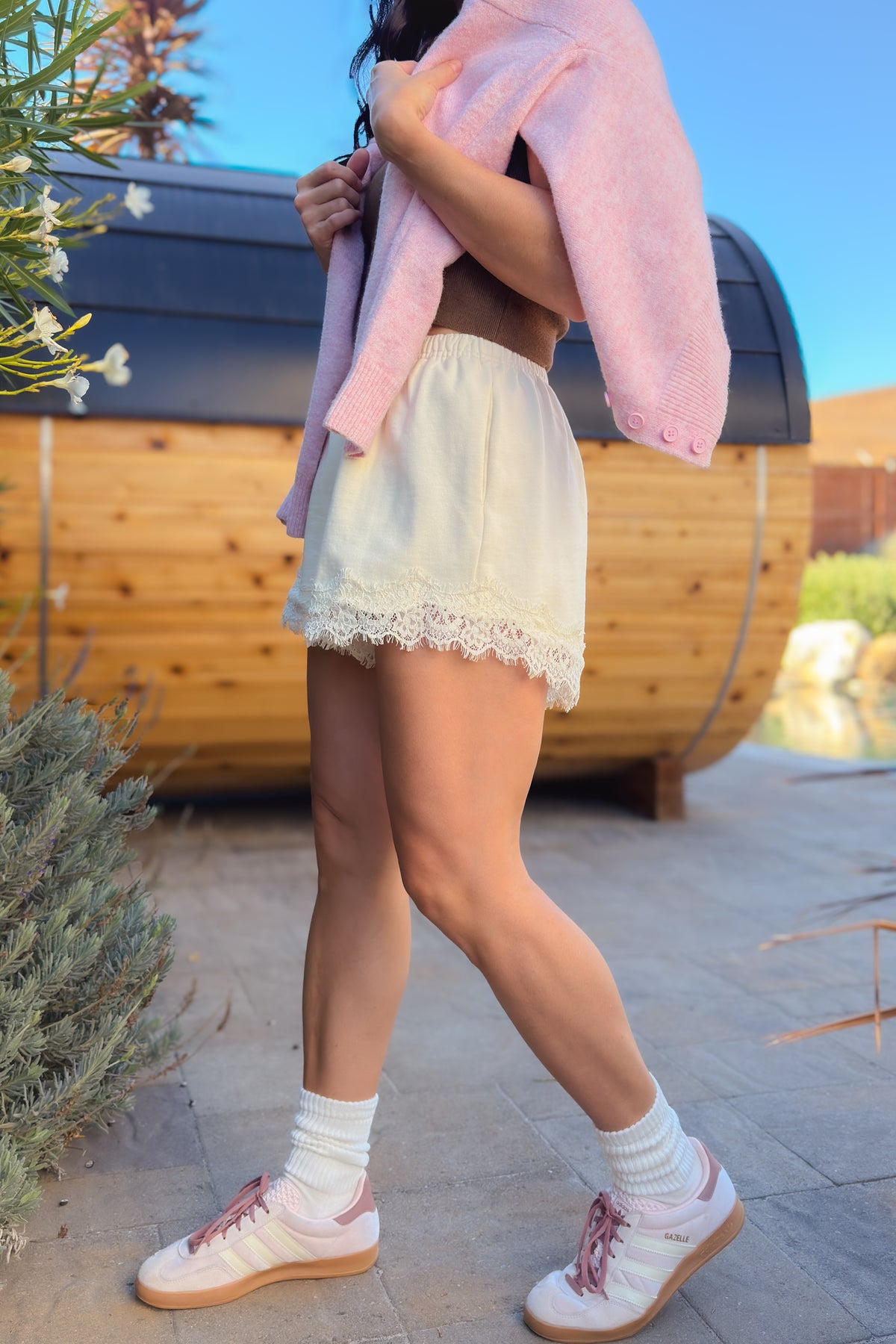 Back view of cream French terry lace shorts with relaxed fit and elastic waist