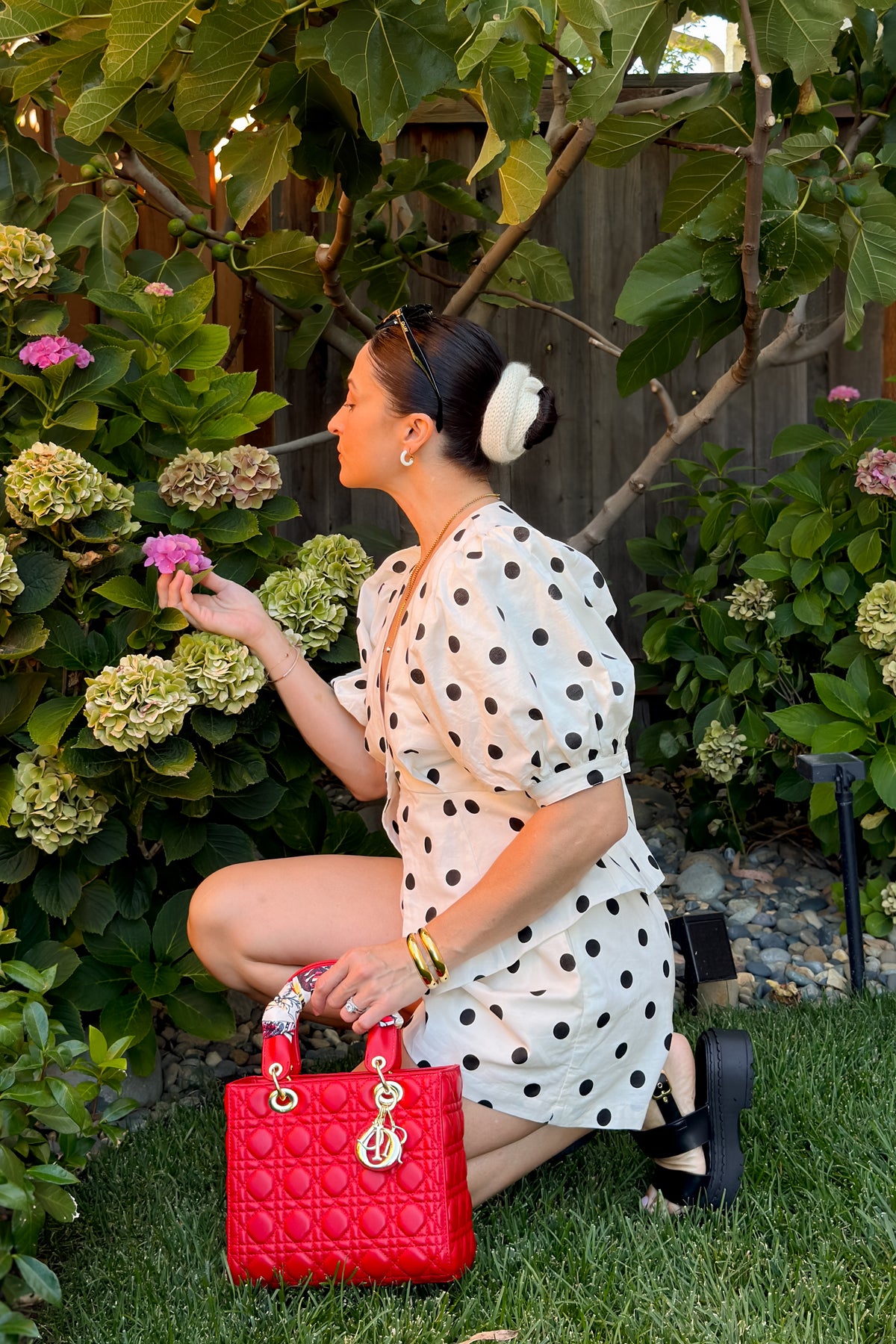 Side view of a cream linen blend short set featuring a tailored peplum top, hidden side zipper shorts, and breathable woven fabric.