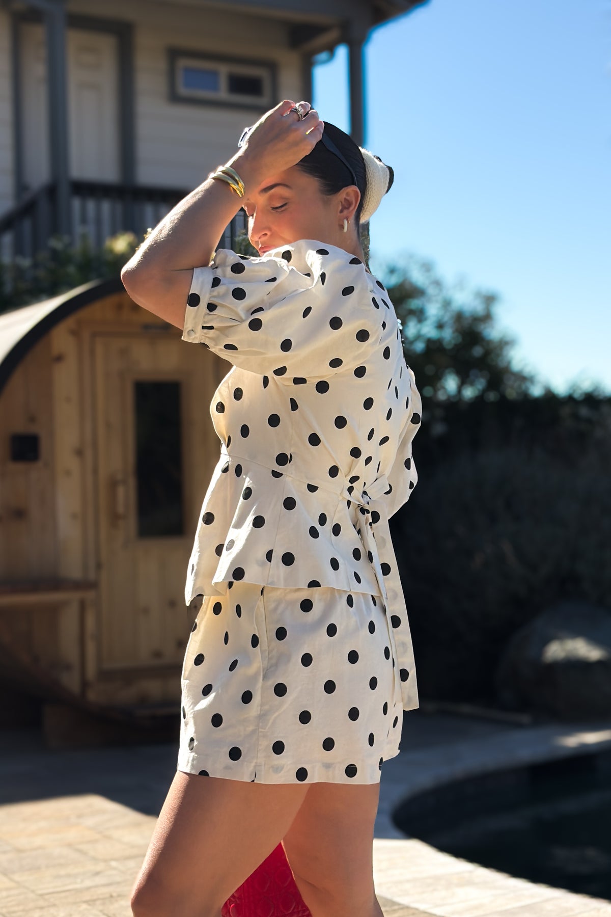 Front view of a cream linen blend matching set styled with black sandals, showcasing the airy fabric and feminine details.