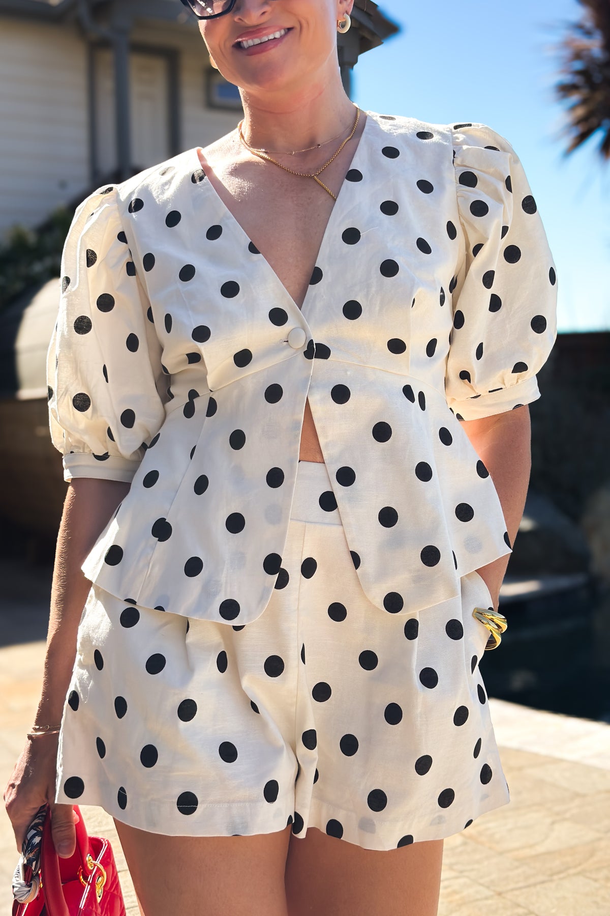 Women's cream cotton linen short set with a flattering peplum silhouette, puff sleeves, and comfortable lined shorts.