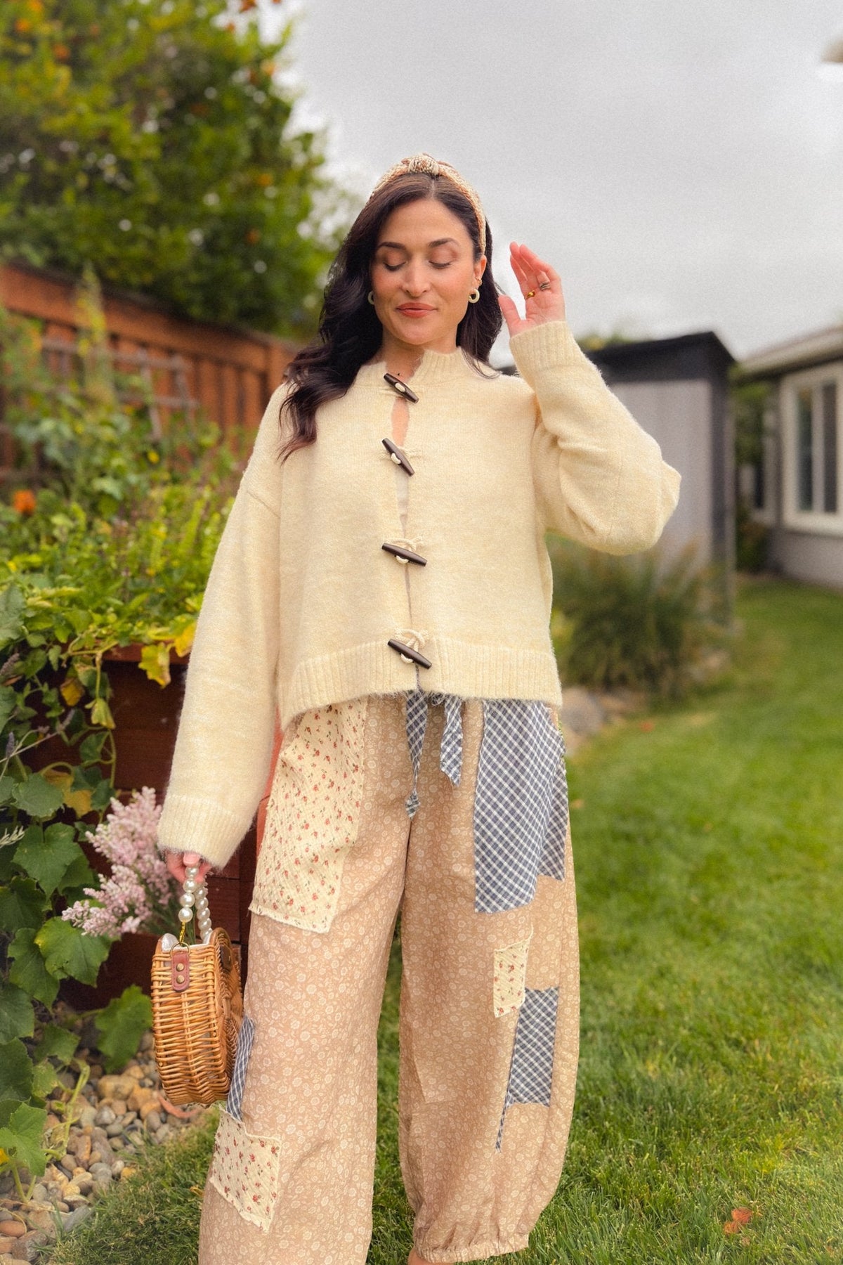 Cream toggle front cardigan styled with beige floral patchwork pants, featuring a soft stretchy knit, roomy sleeves and slightly cropped hem.