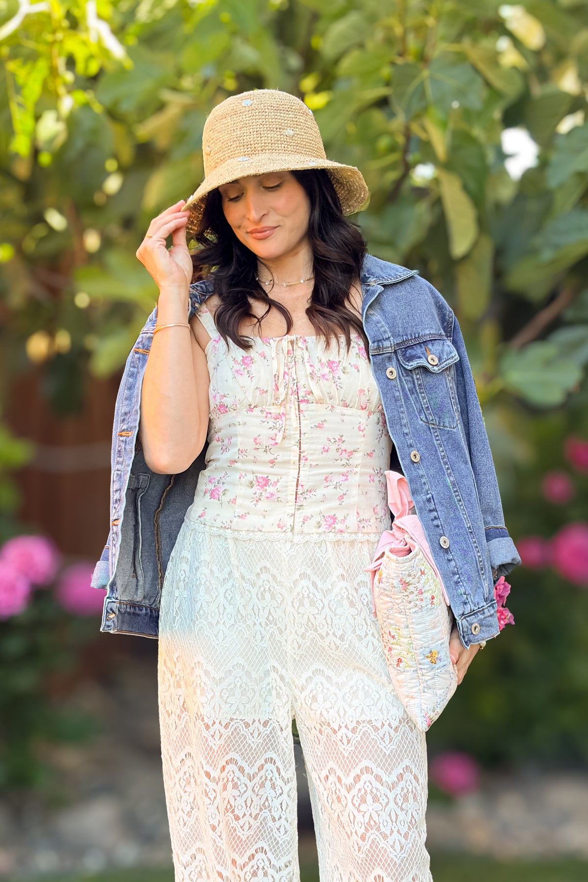 Soft quilted floral Bible cover featuring a feminine patchwork print and oversized pink bow for carrying a Bible and devotional supplies.