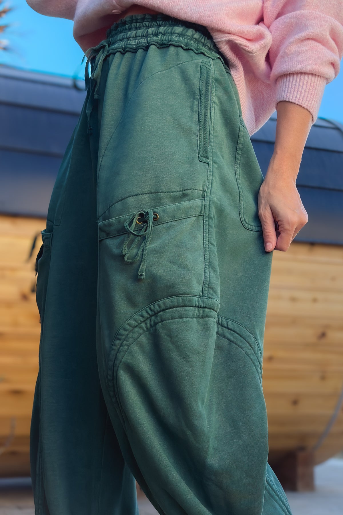 Women’s green cargo pants with elastic drawstring waist and relaxed wide leg silhouette