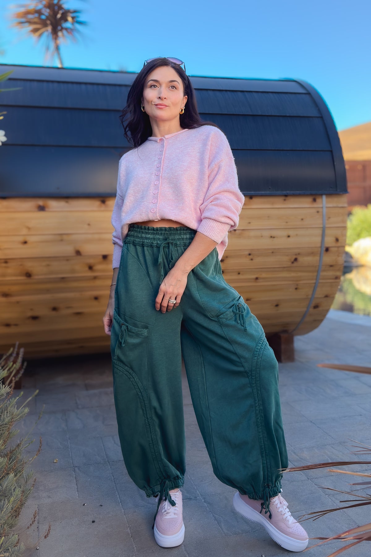 Green wide leg utility pants with oversized cargo pockets and adjustable ankle ties