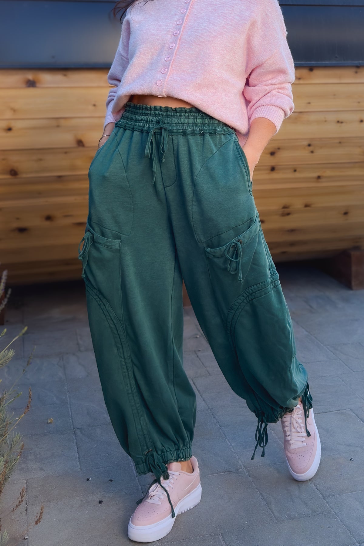 Green balloon-style cargo pants for women with cinchable ankles and utility pockets