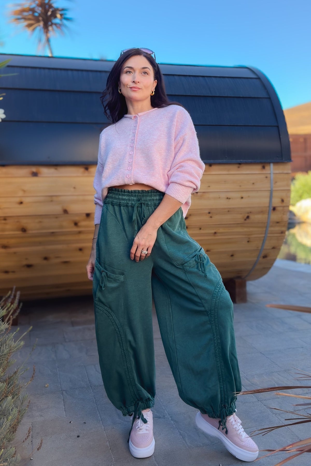 Green wide leg utility pants with oversized cargo pockets and adjustable ankle ties