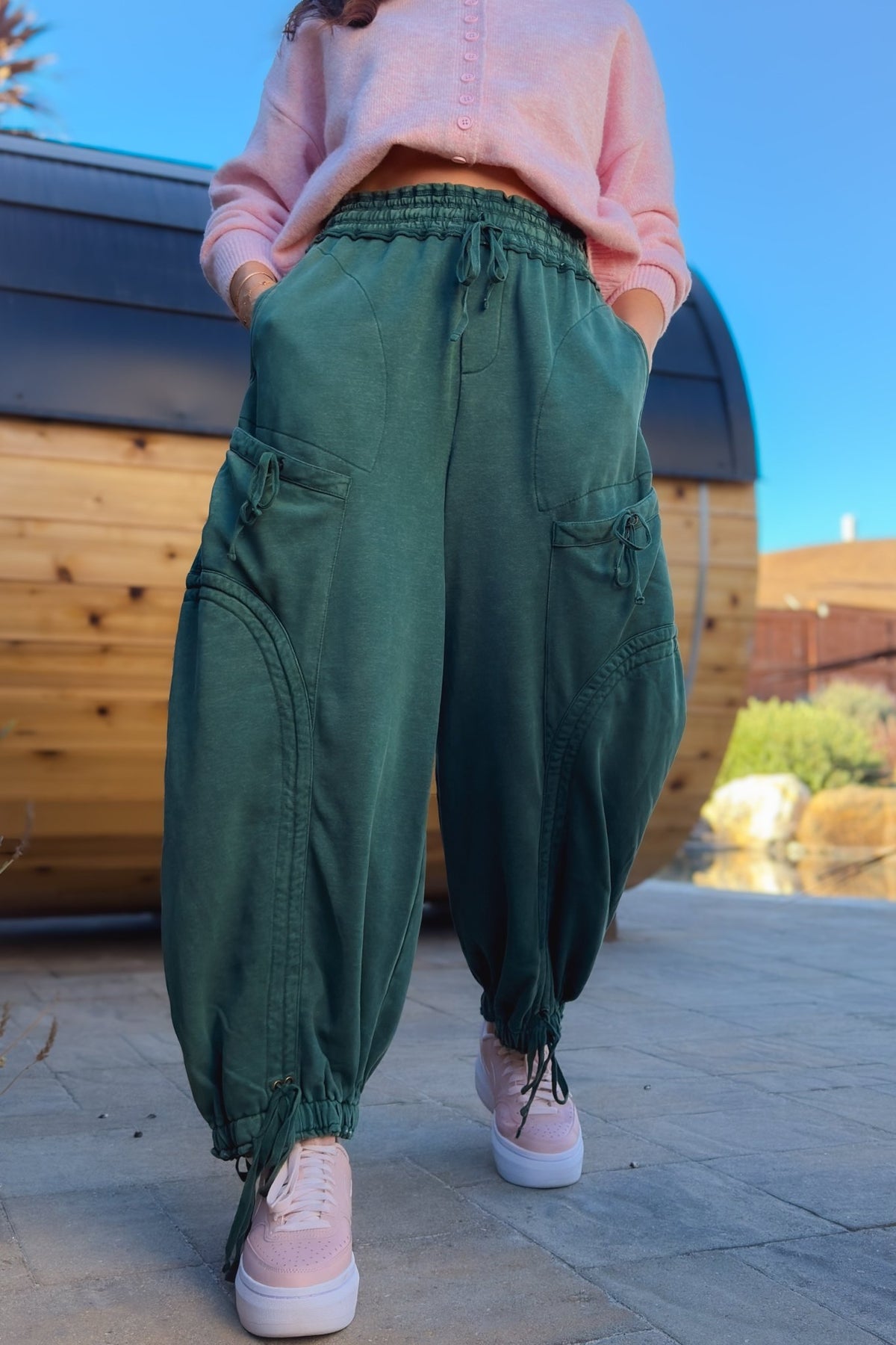 Relaxed green utility pants with wide leg fit, elastic waistband and cargo pockets
