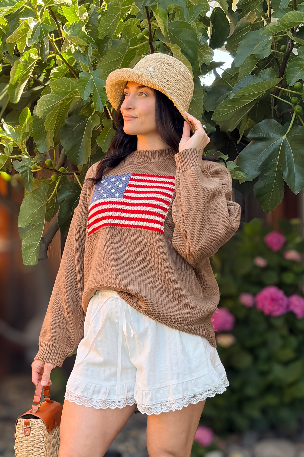 Close-up of brown American flag knit sweater featuring an oversized fit and heritage-inspired design.