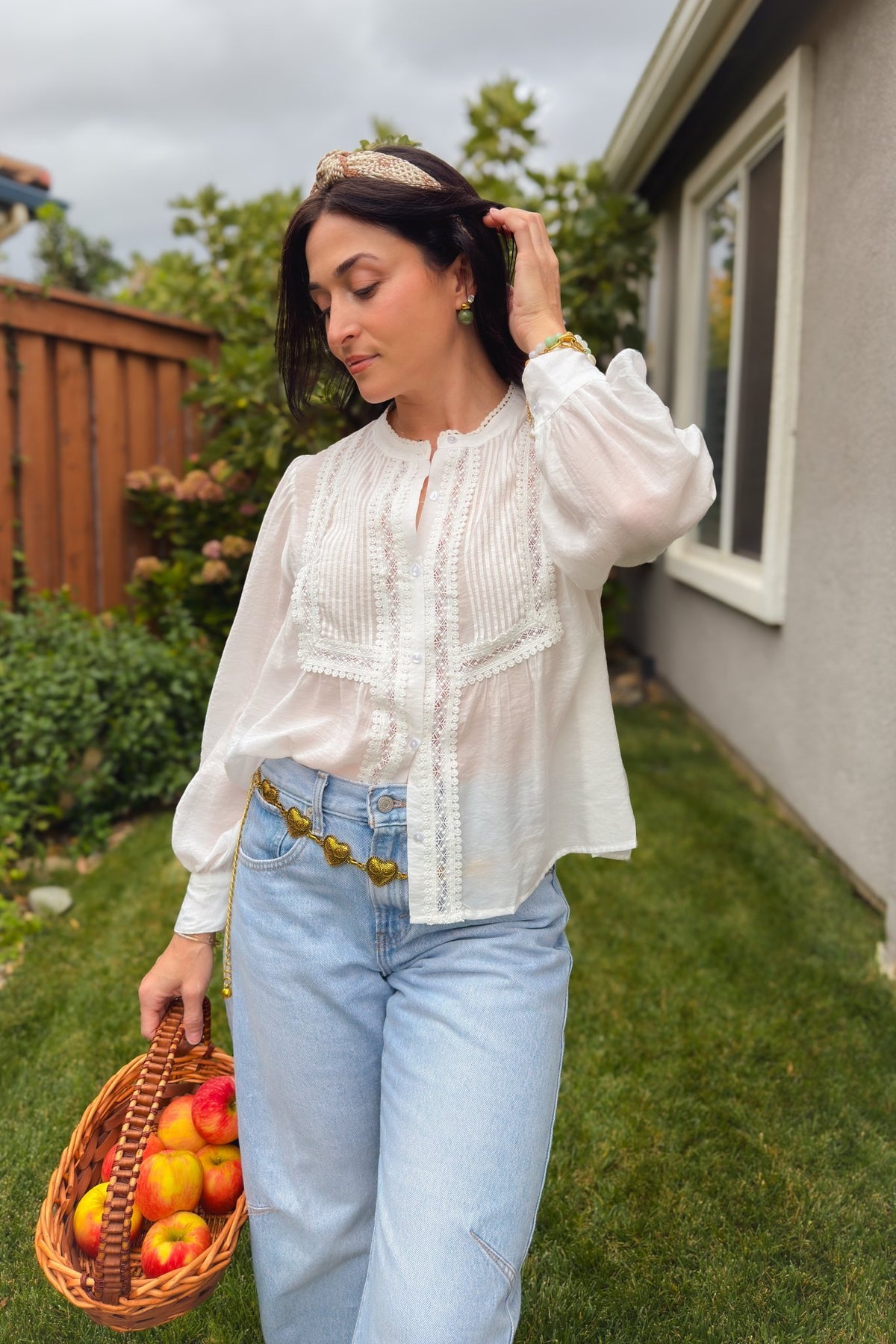 Lightweight white cotton blouse styled with blue jeans for a feminine fall outfit