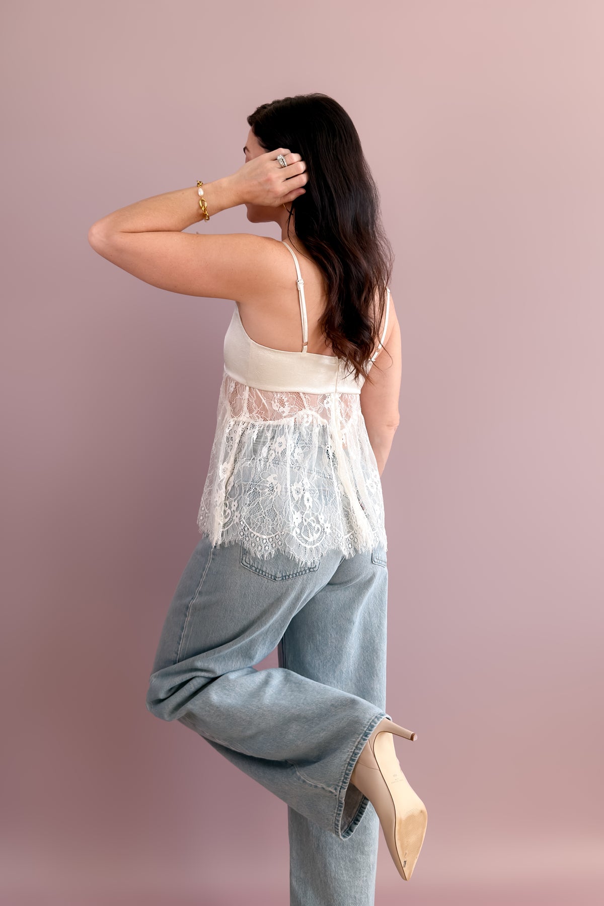 Side view of ivory lace peplum cami showing its flowing, relaxed silhouette.