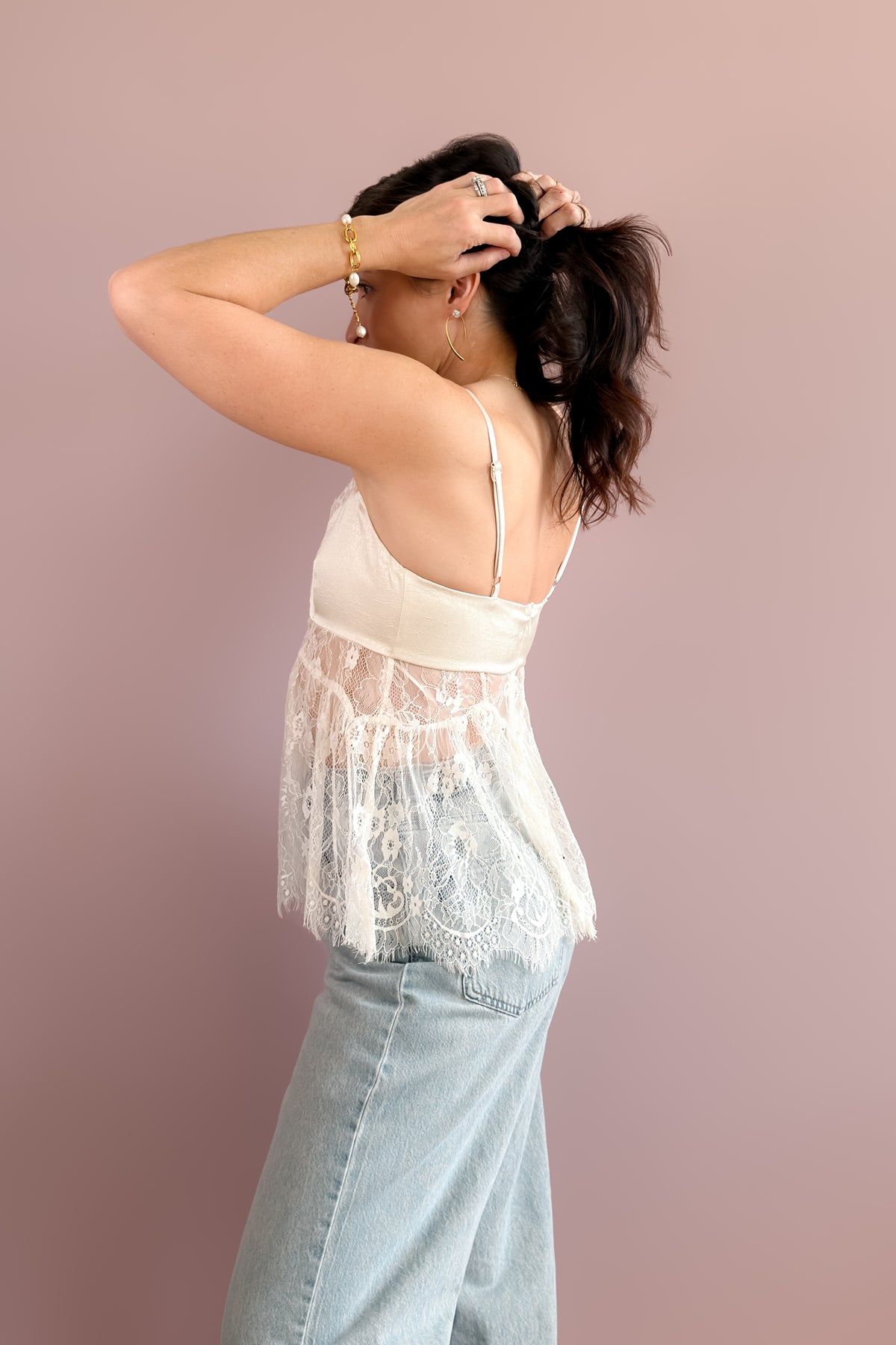 Women's ivory lace peplum camisole styled beneath a chocolate brown faux suede bomber jacket.