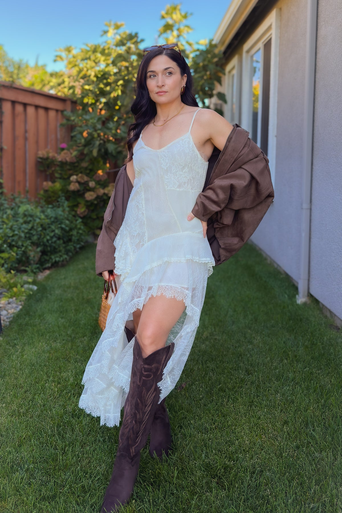 Ivory lace slip dress with romantic asymmetrical layers styled for transitional weather