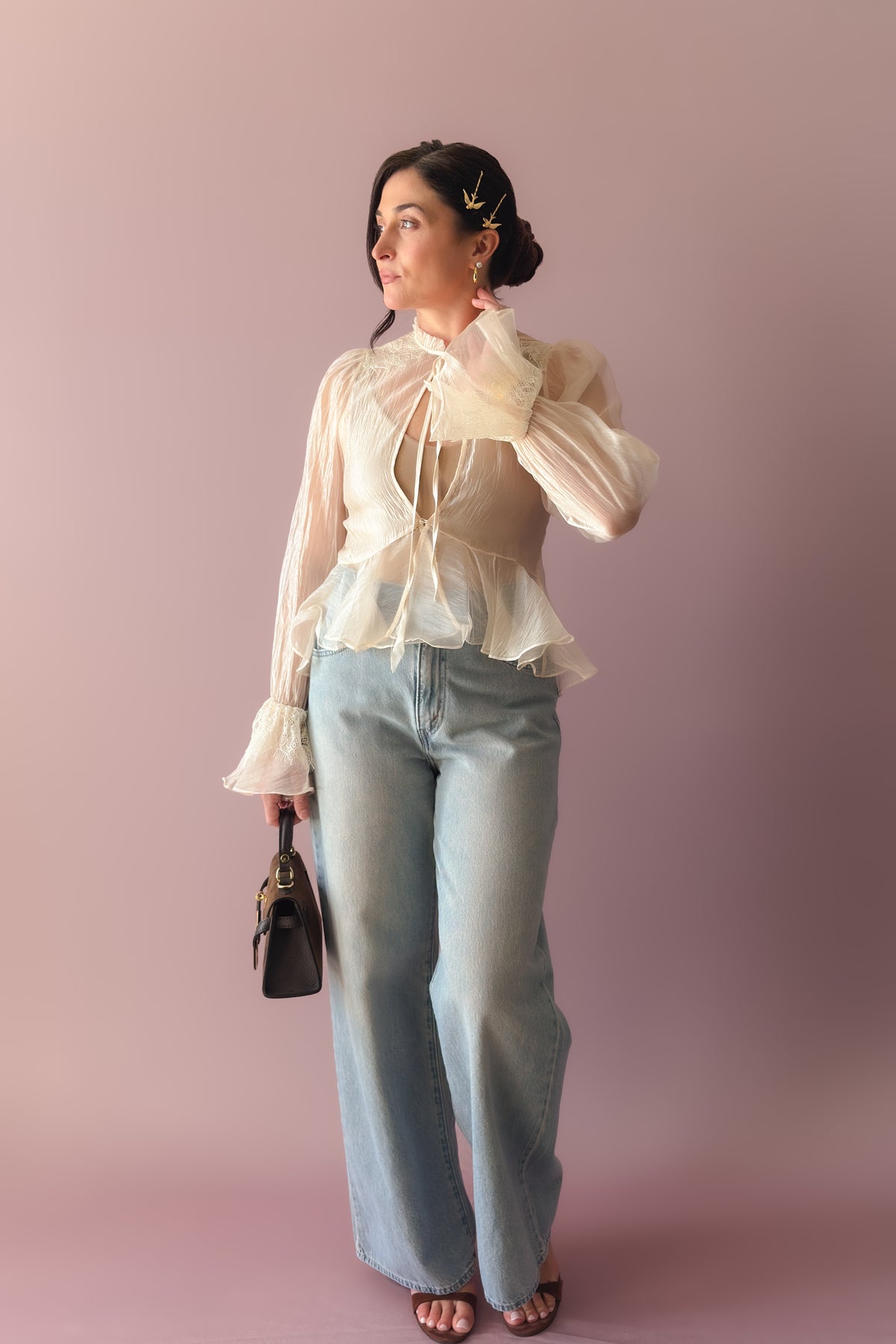 Women’s sheer ivory peplum top with lace cuffs, front ties and delicate gem button