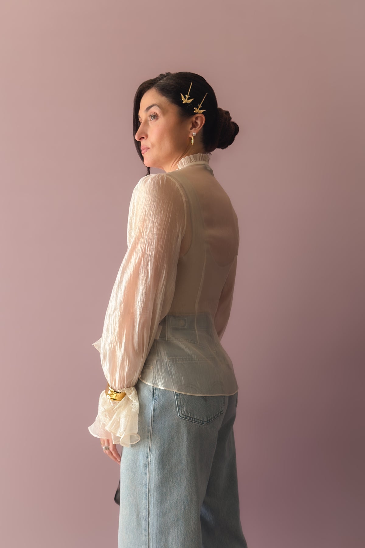 Romantic ivory organza blouse styled casually with wide leg jeans and brown sandals