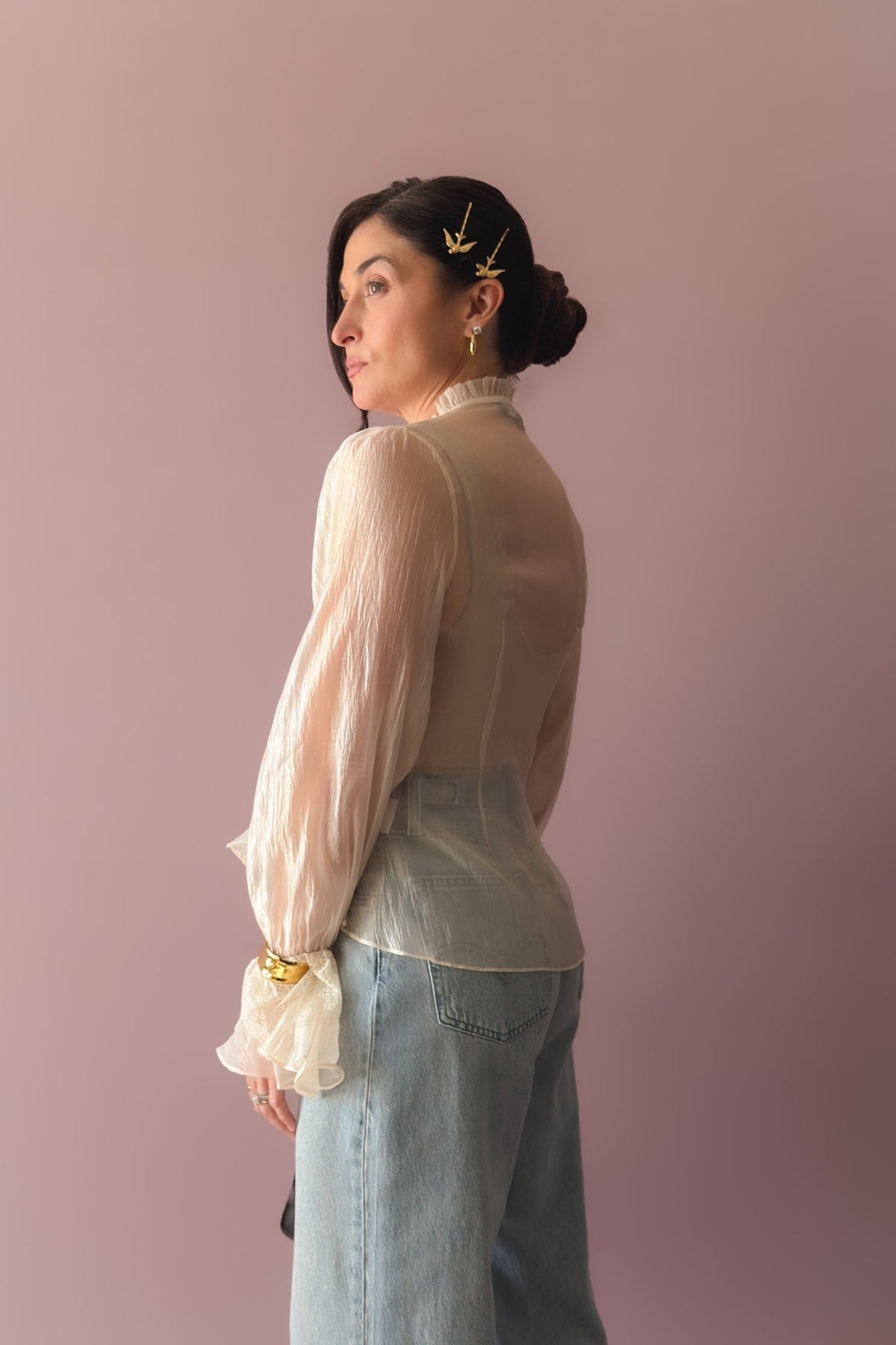Romantic ivory organza blouse styled casually with wide leg jeans and brown sandals