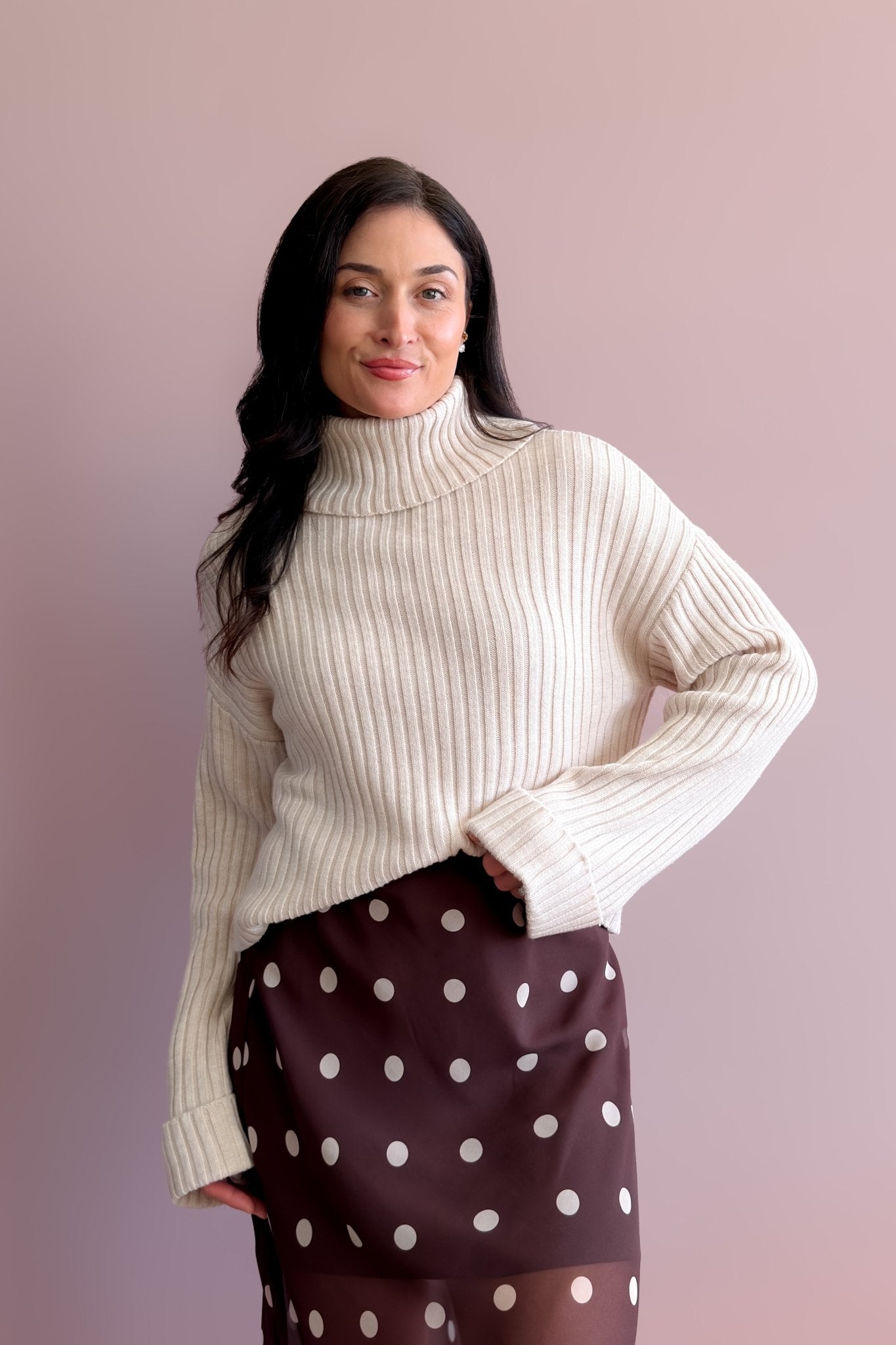 Light beige ribbed merino wool blend turtleneck sweater with relaxed boxy fit and drop shoulders
