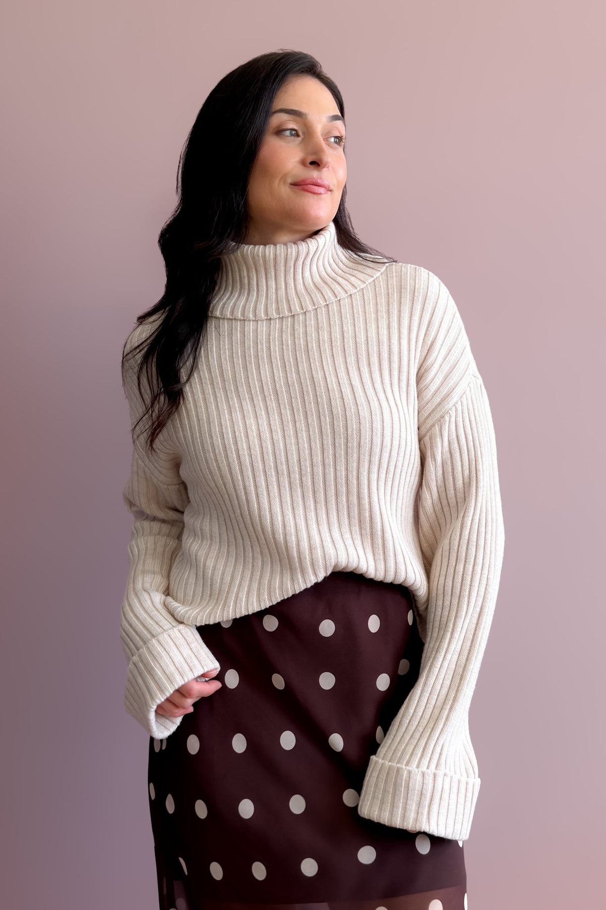 Neutral ribbed turtleneck sweater in a soft merino wool blend with relaxed silhouette