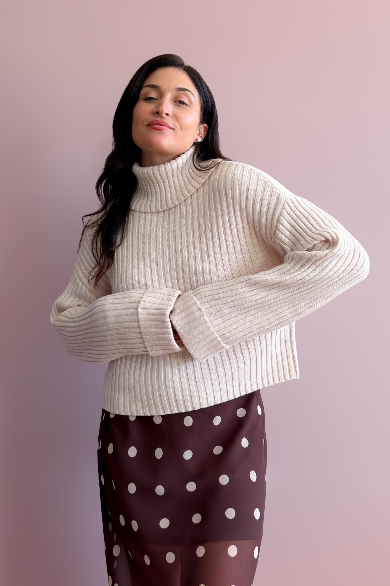 Light beige ribbed merino wool blend turtleneck sweater with relaxed boxy fit and drop shoulders